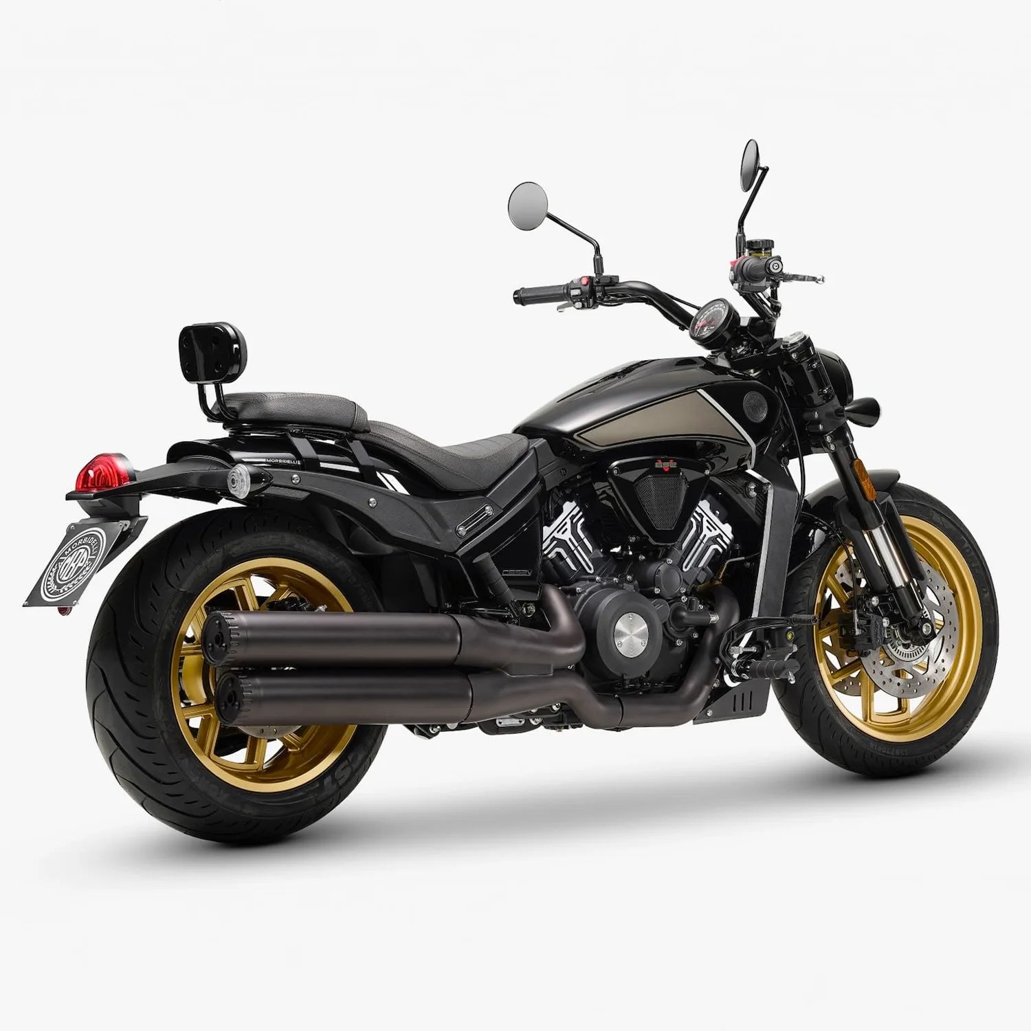 Black cruiser motorcycle with gold wheels and dual black exhaust pipes on a white background.