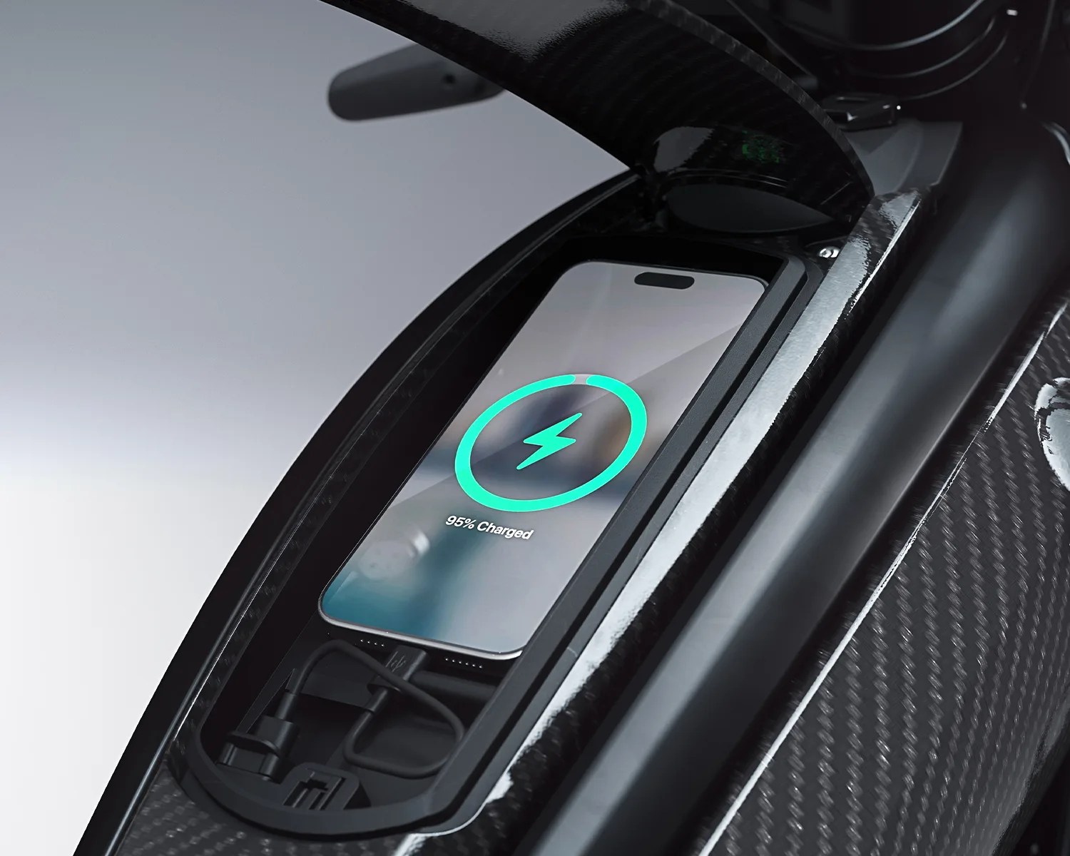 Smartphone with 95% charged battery icon on screen placed in a carbon fiber compartment with charging cables.