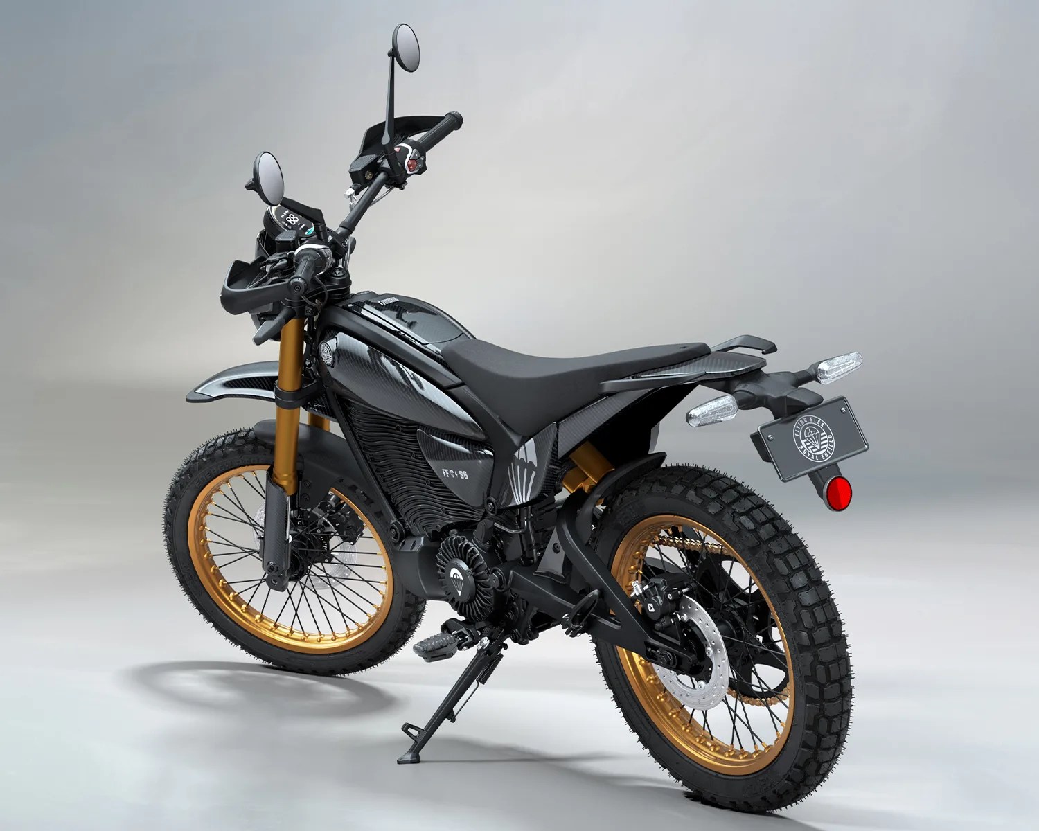 Black electric motorcycle with gold rims and knobby tires on a gray background.