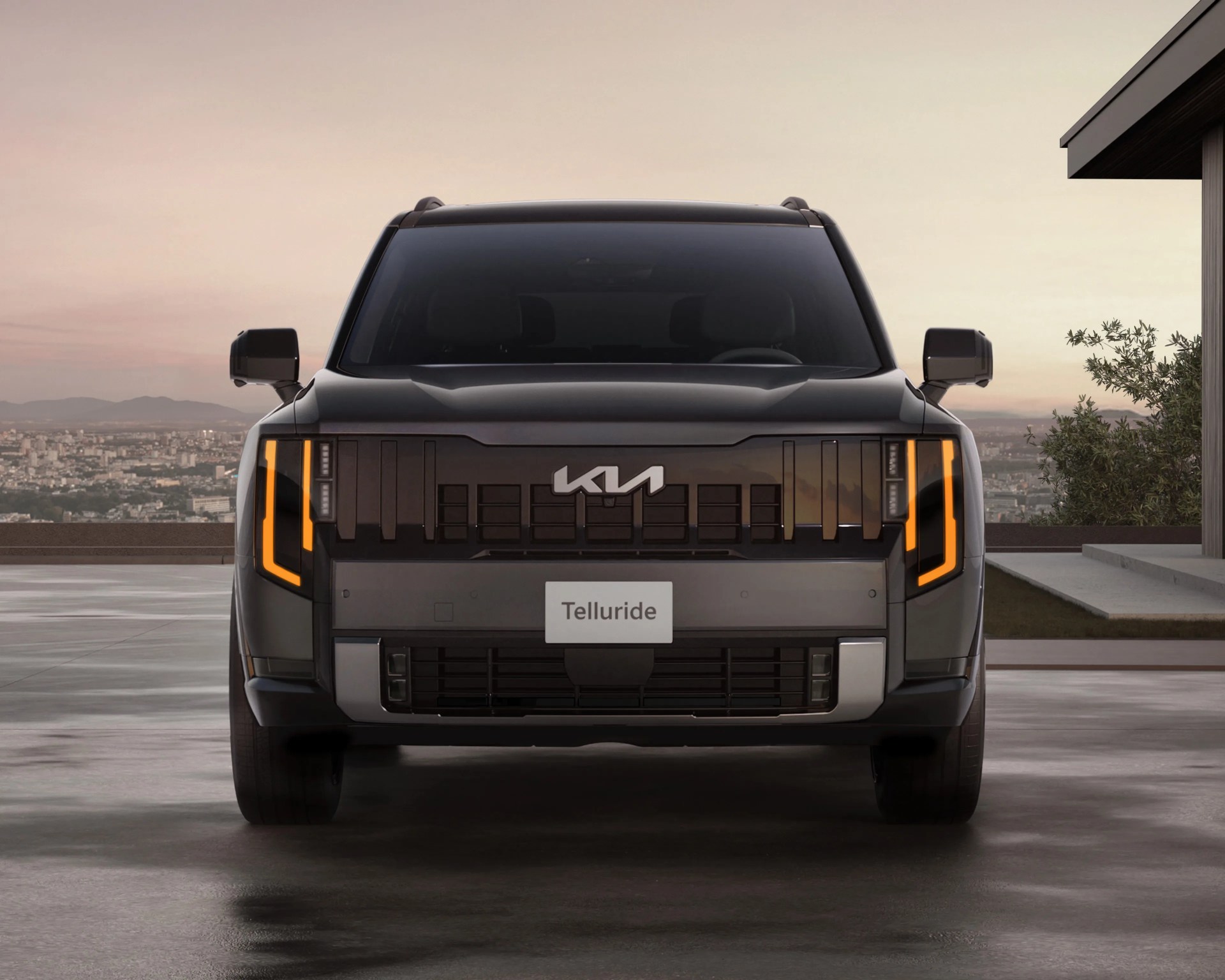Front view of a black Kia Telluride SUV with illuminated vertical LED headlights and a modern grille.