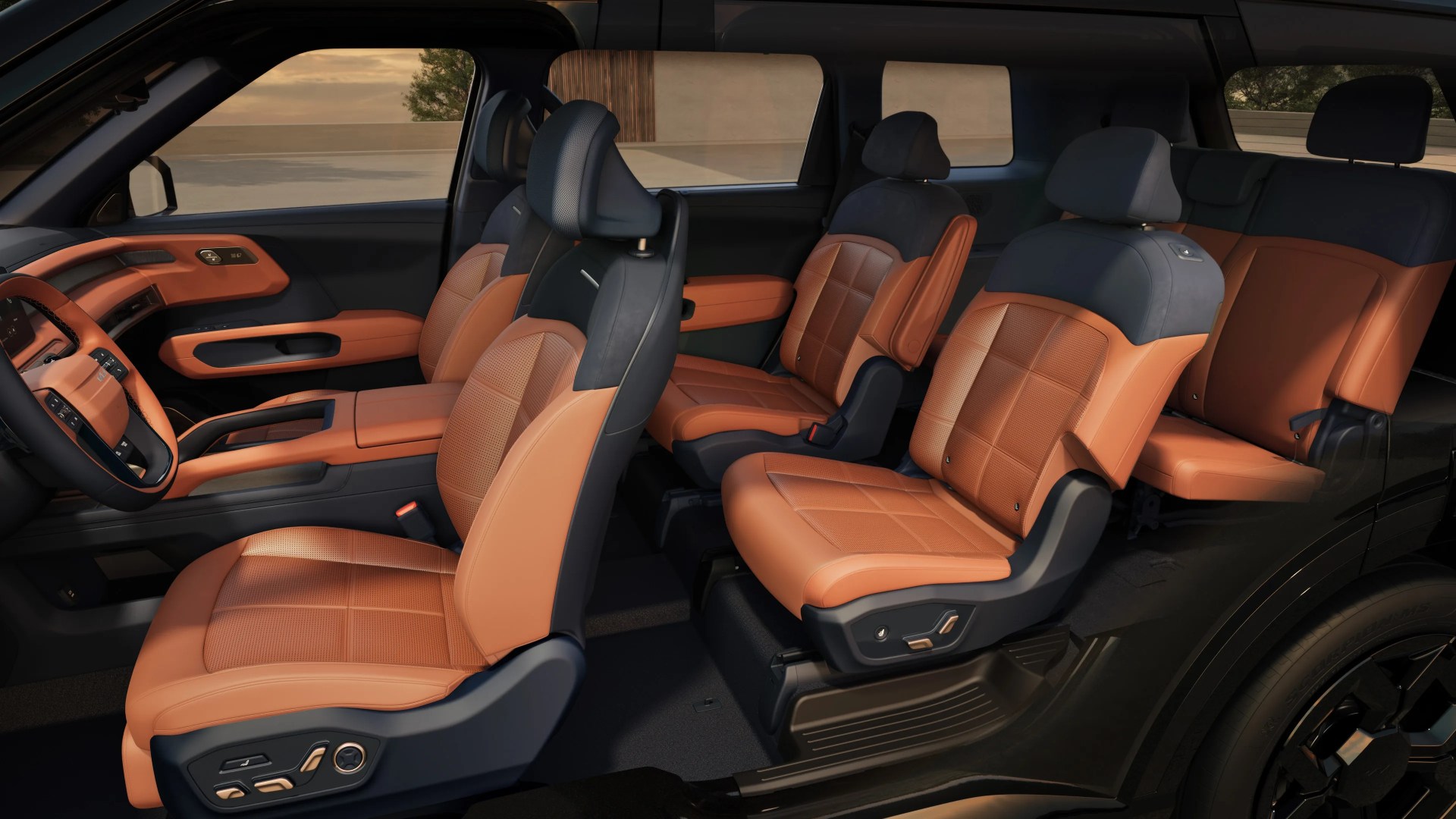 Interior of a black SUV showing three rows of tan leather seats with black headrests and door panel accents.