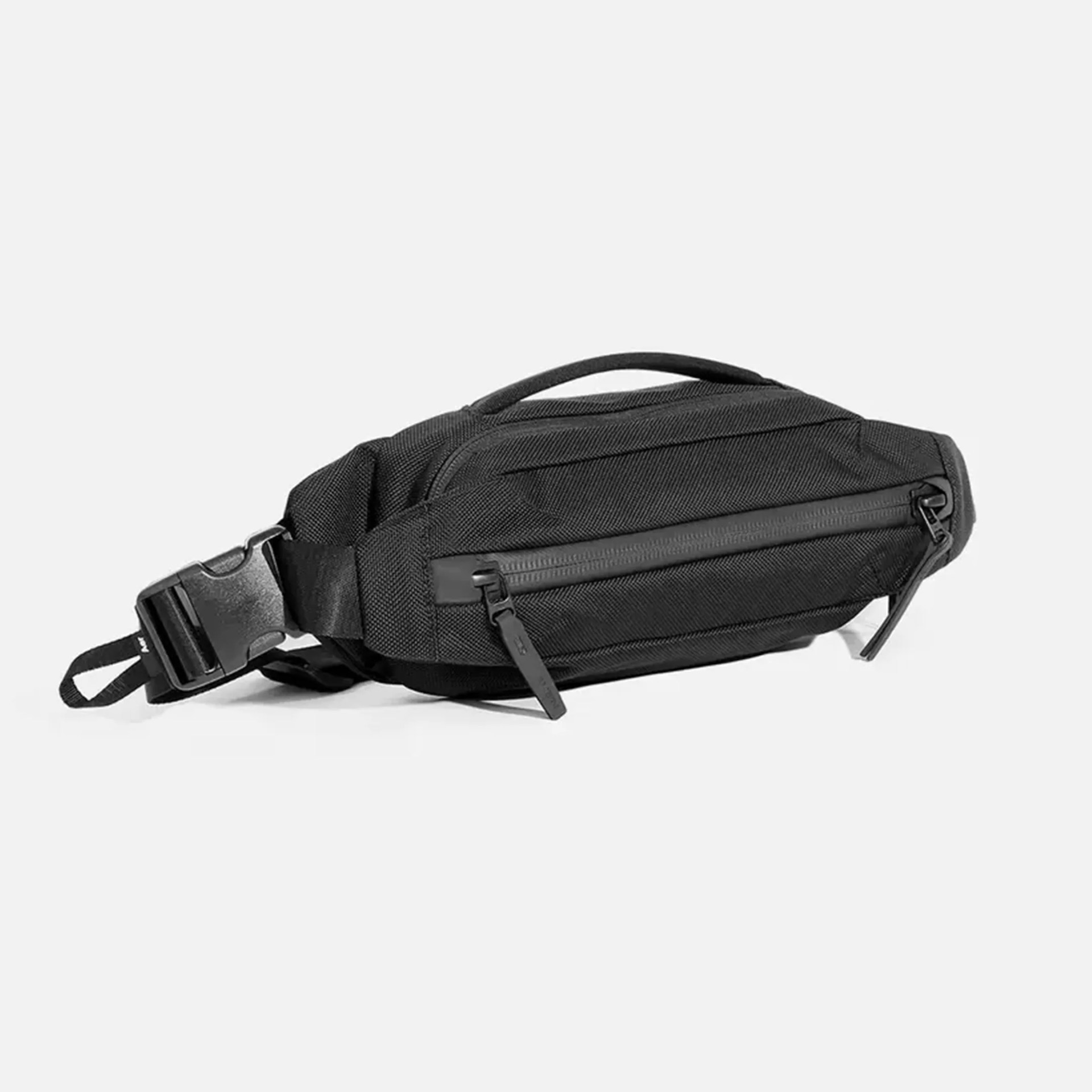 Black nylon waist bag with two zippered compartments and a plastic buckle strap.