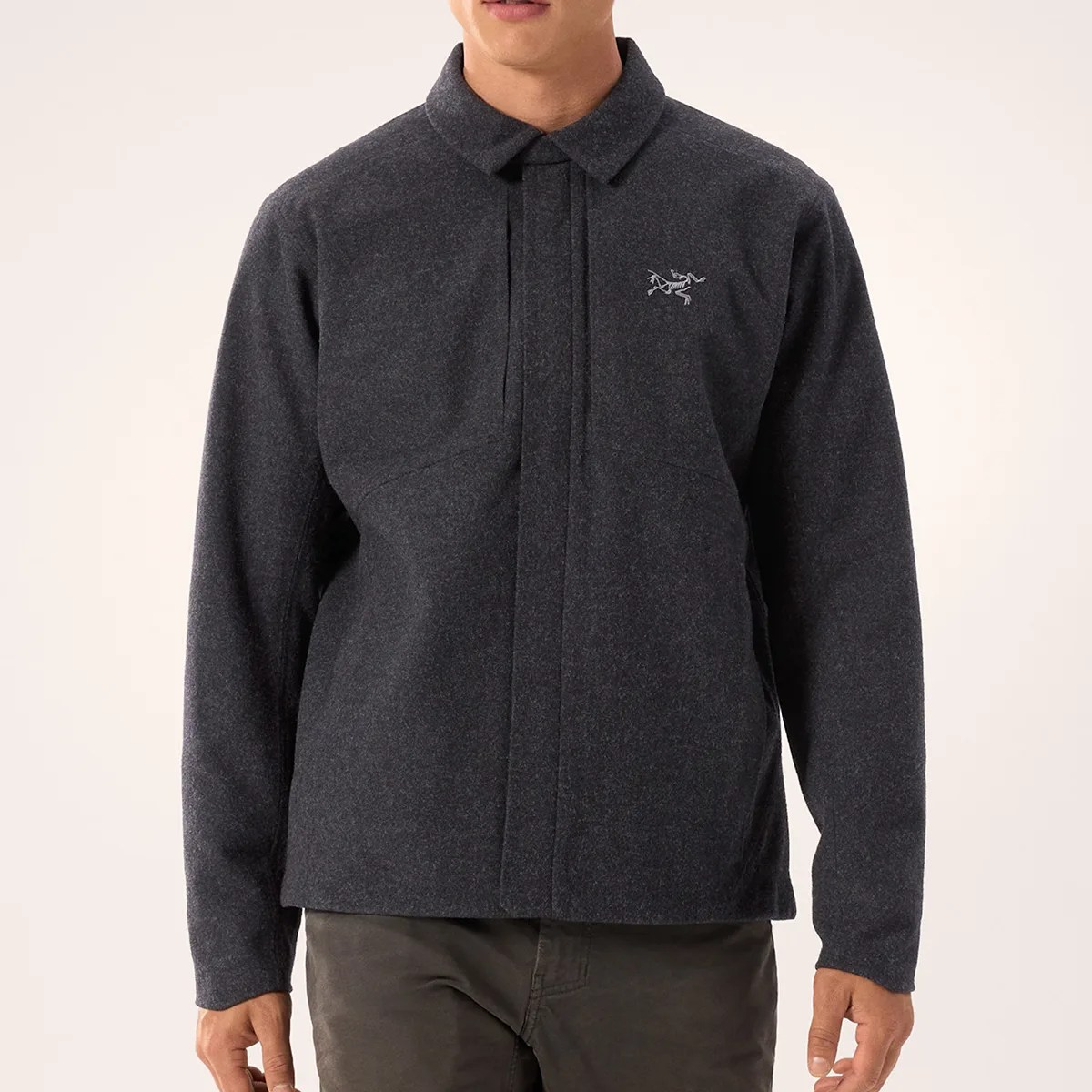 Dark gray fleece jacket with collar and hidden front zipper worn by a person.