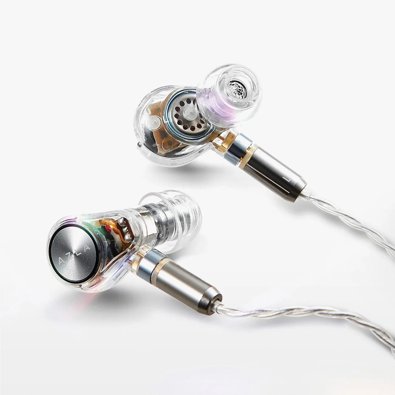 Transparent wired in-ear monitors with visible internal components and metal accents on a white background.