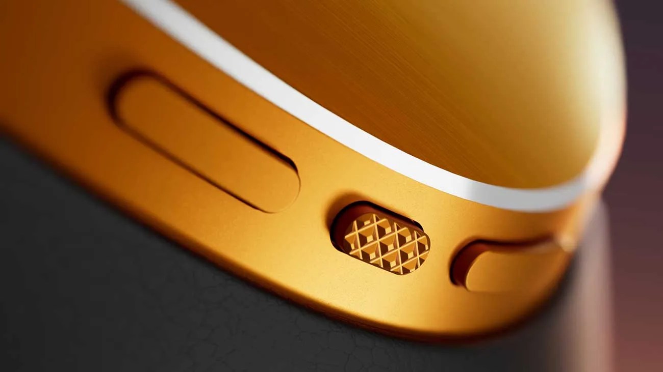 Close-up of a gold-colored Apple Watch Digital Crown with a textured pattern and adjacent buttons.