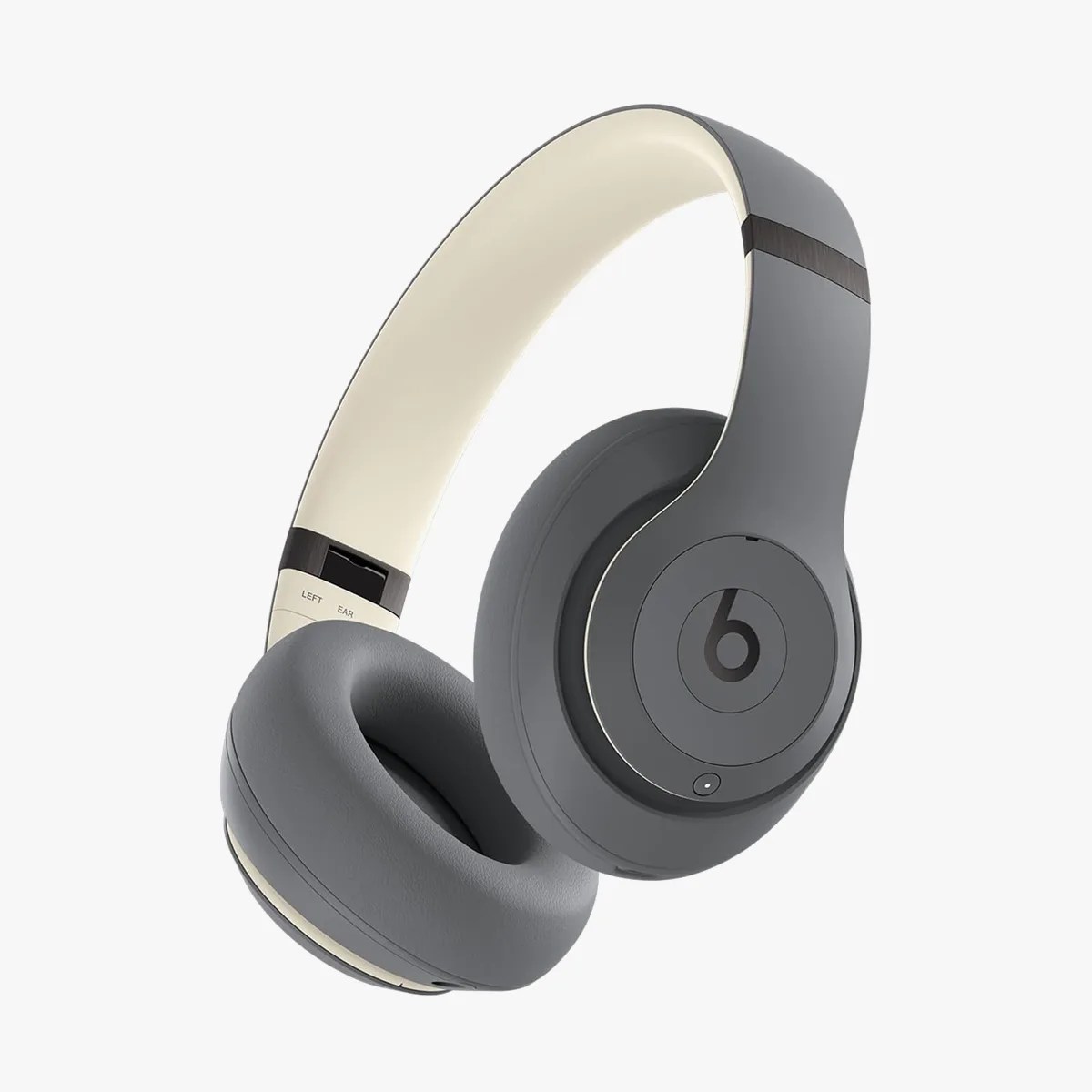 Gray over-ear Beats headphones with cushioned ear pads and cream-colored inner headband.