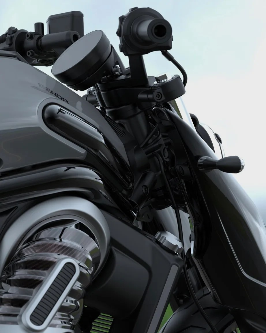 Close-up of a black and gray motorcycle handlebar and front suspension with visible cables and controls.
