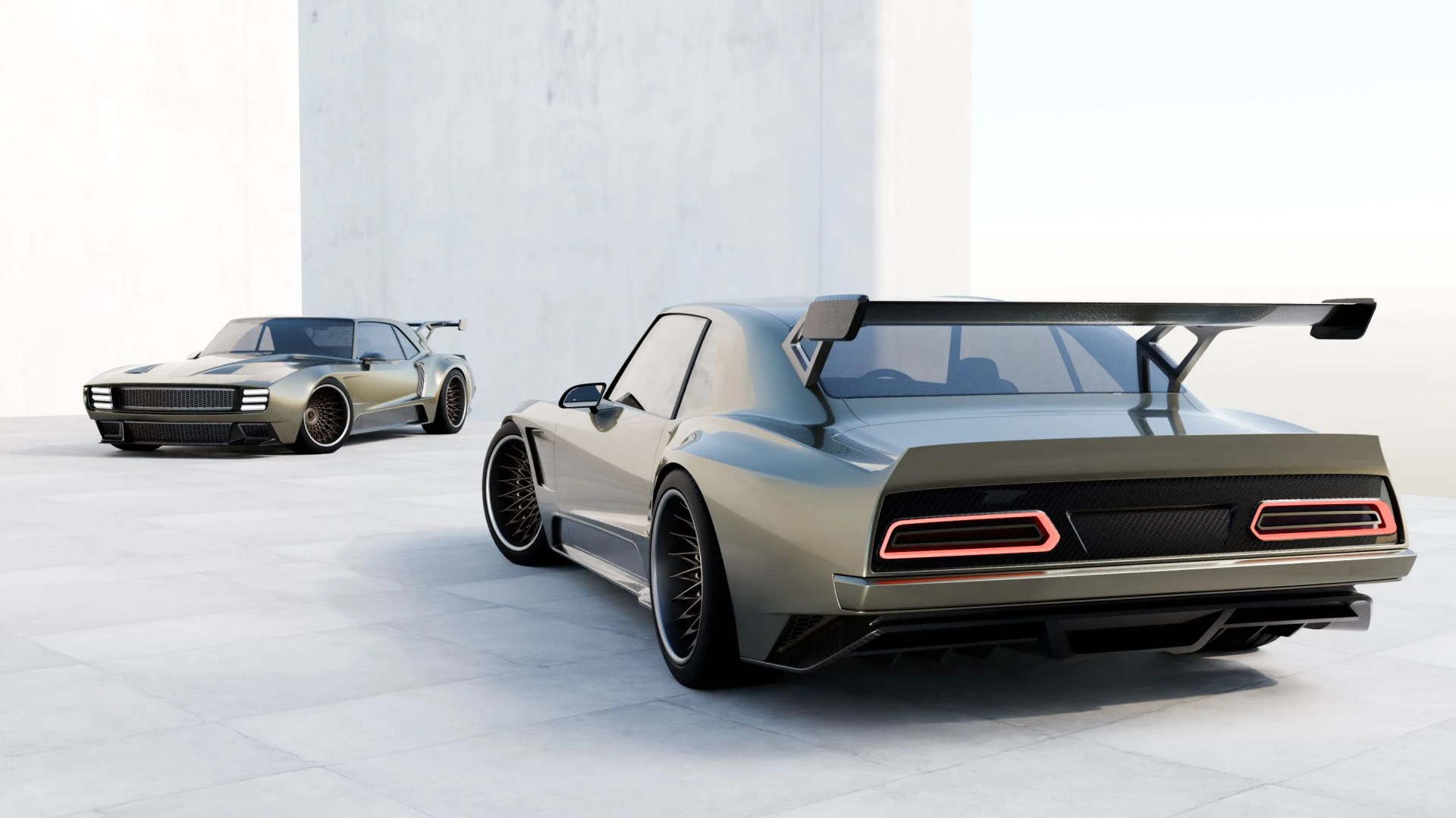 Two metallic gray sports cars with wide bodies, large rear wings, and black multi-spoke wheels on a light tiled surface.