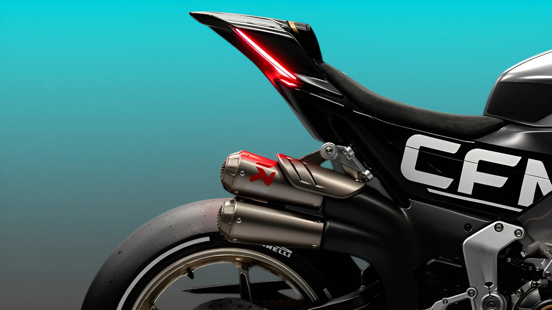 Close-up of a black motorcycle rear with dual Akrapovič exhausts, red LED tail light, and gold wheel rim.