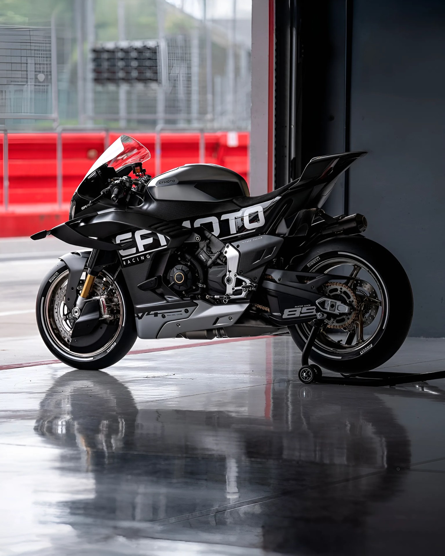 Black and silver CFMOTO sport motorcycle with racing decals on a reflective garage floor.