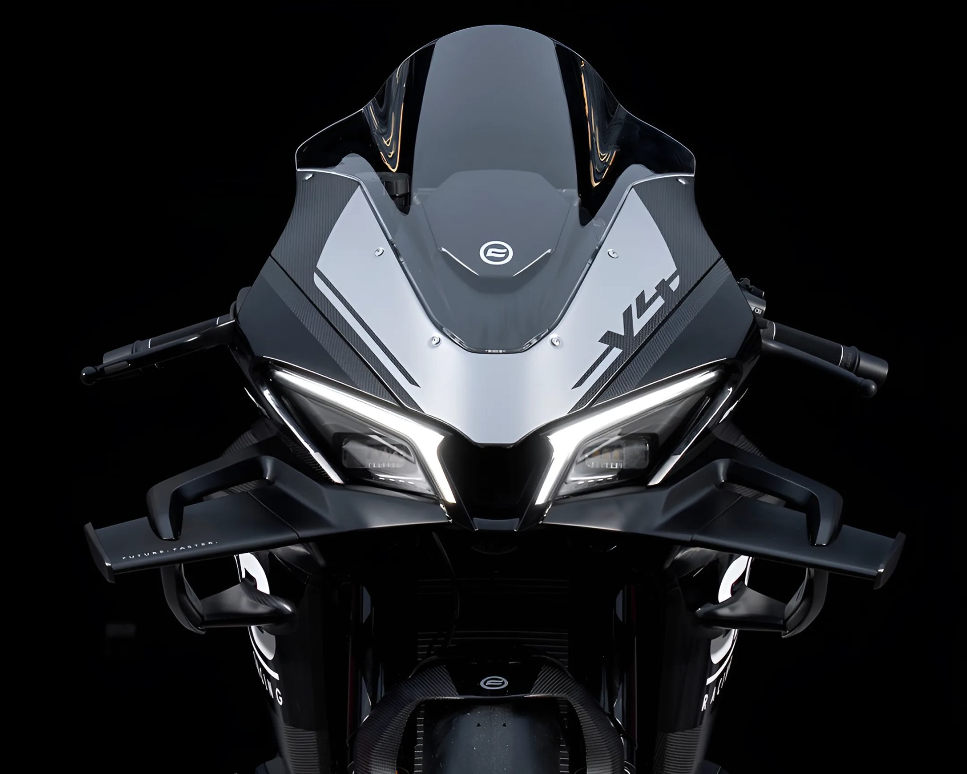 Front view of a black and silver sport motorcycle with angular LED headlights and aerodynamic winglets.
