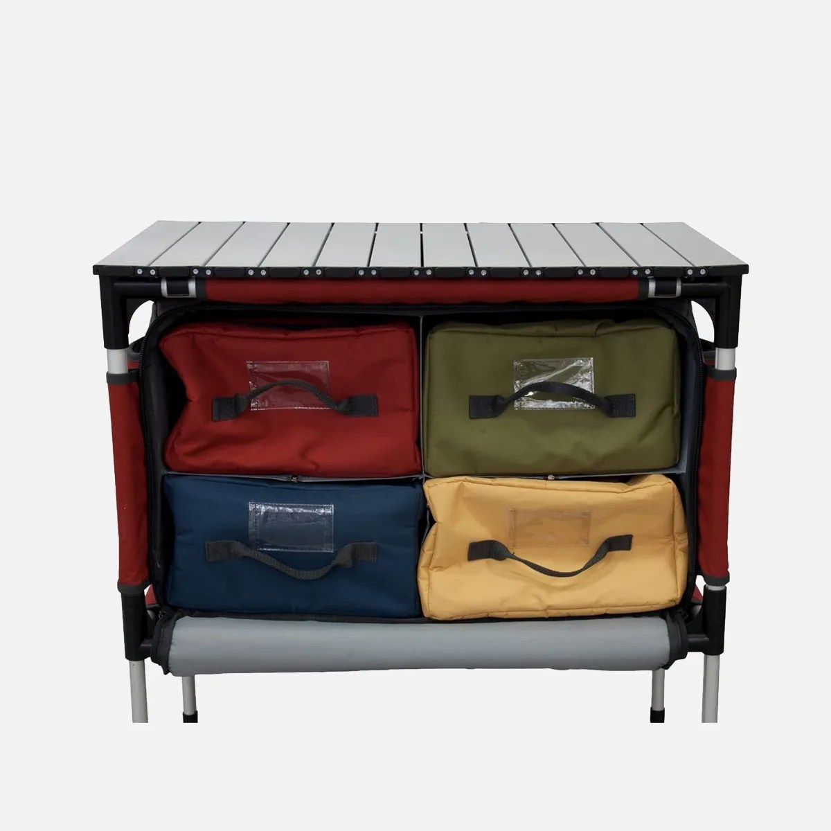 Compact camping table with a silver slatted top and four colorful fabric storage bags underneath.