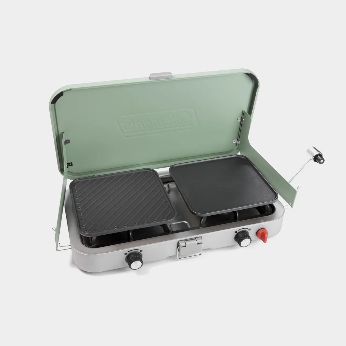 Portable two-burner camping stove with green lid, black grill and griddle plates, and silver body.