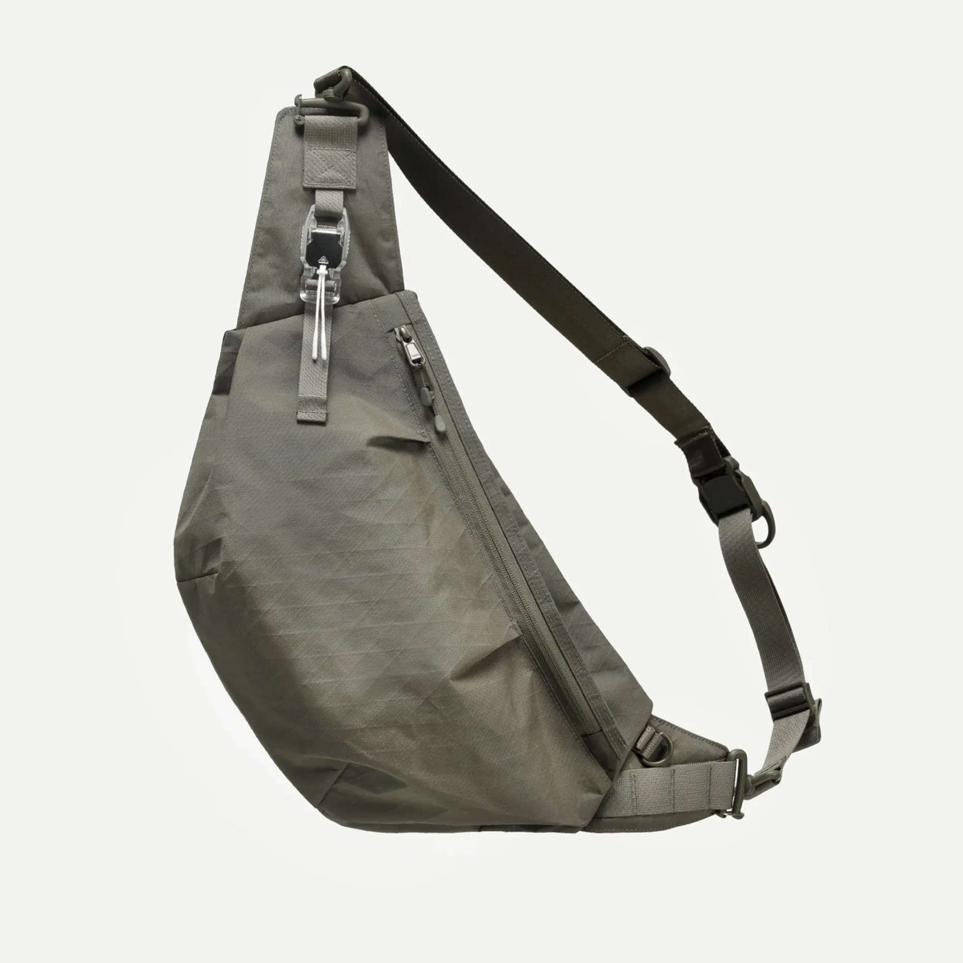 Olive-green sling bag with adjustable strap and front zipper pocket.