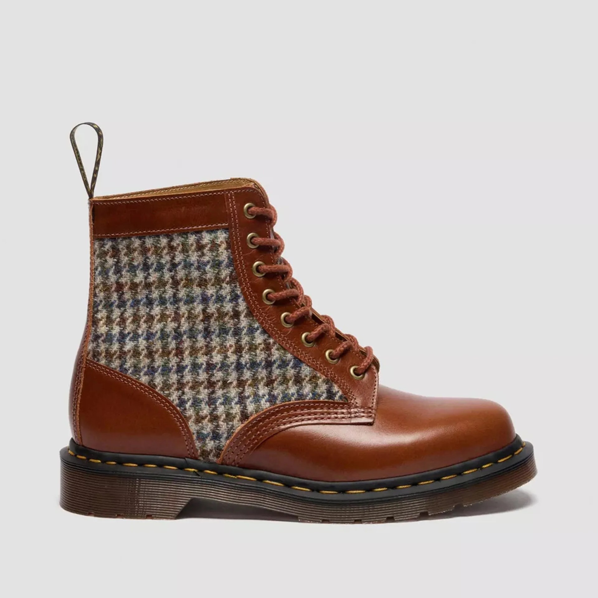 Brown leather and multicolor houndstooth fabric lace-up boot with black sole and yellow stitching.