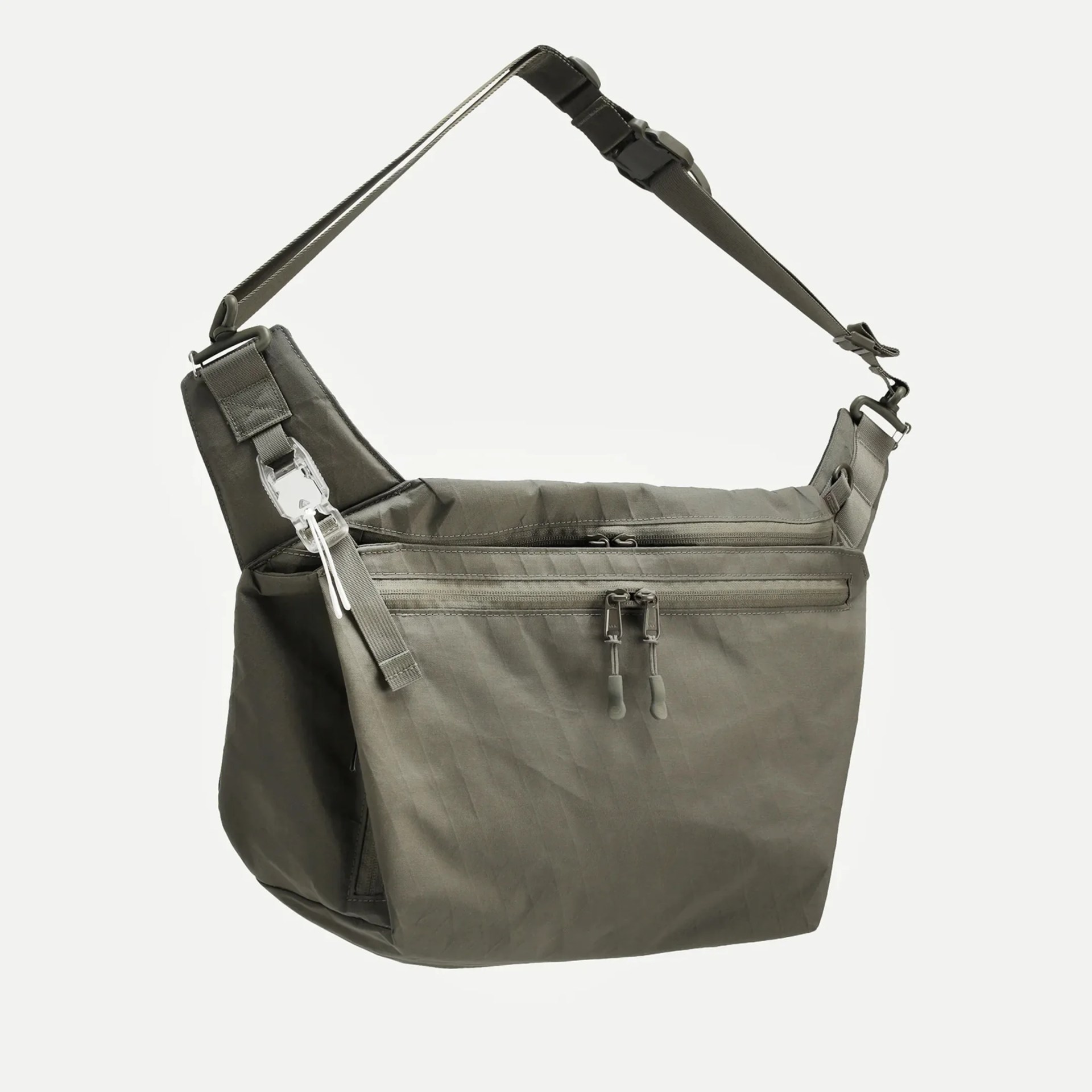 Olive green crossbody bag with multiple zippered compartments and adjustable strap.