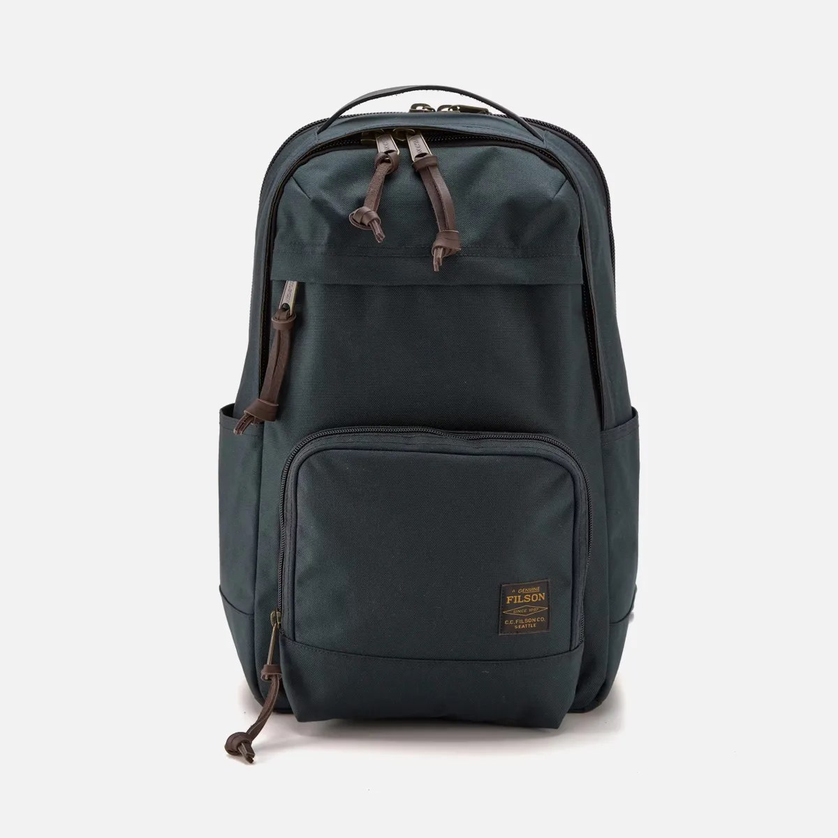 Dark green Filson backpack with multiple zippered compartments and leather zipper pulls.