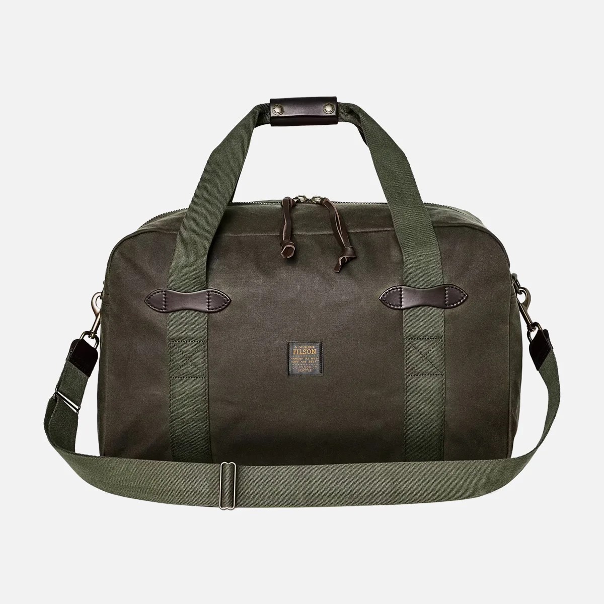 Olive green canvas duffel bag with leather accents and adjustable shoulder strap.
