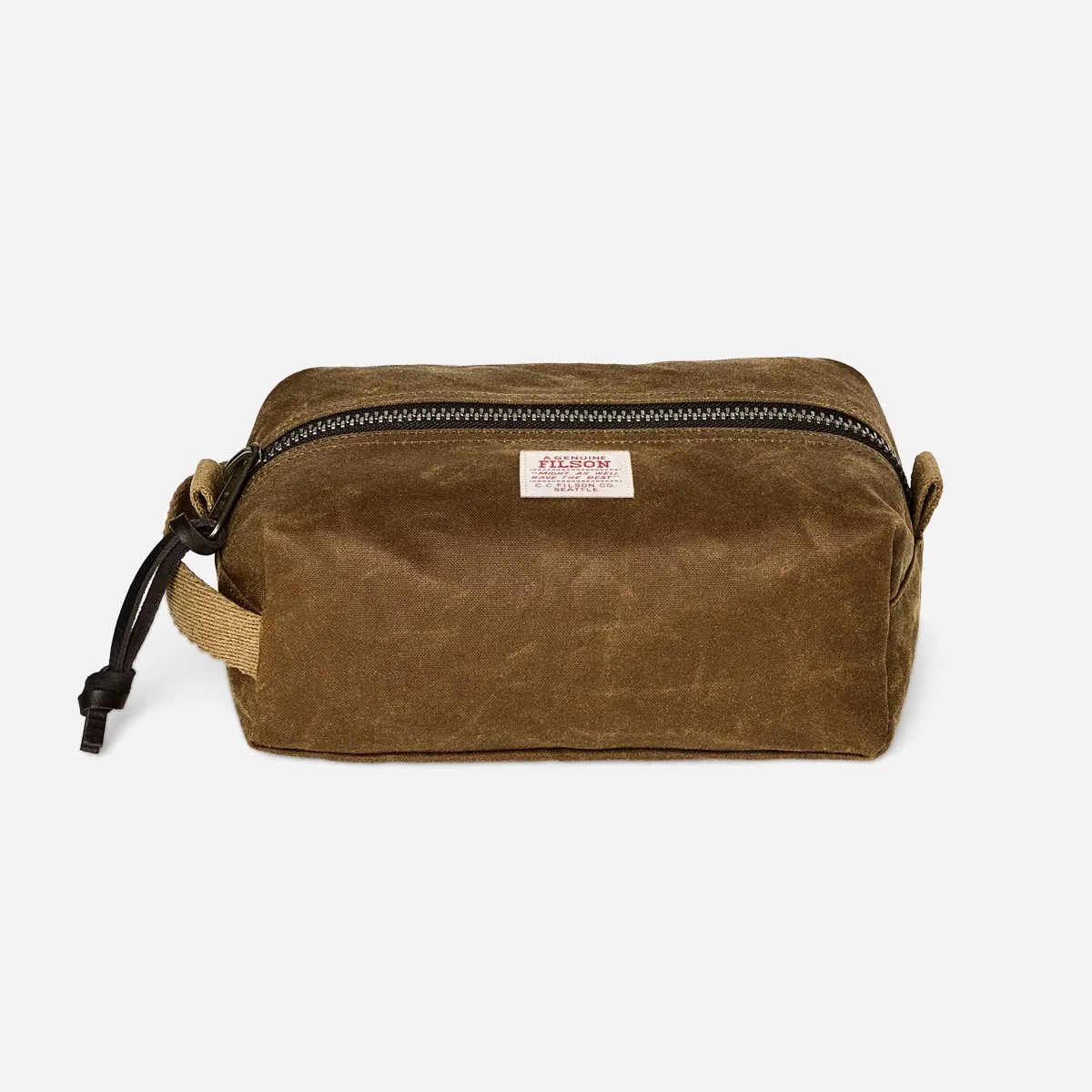 Brown waxed canvas rectangular toiletry bag with black zipper and fabric handle loop.