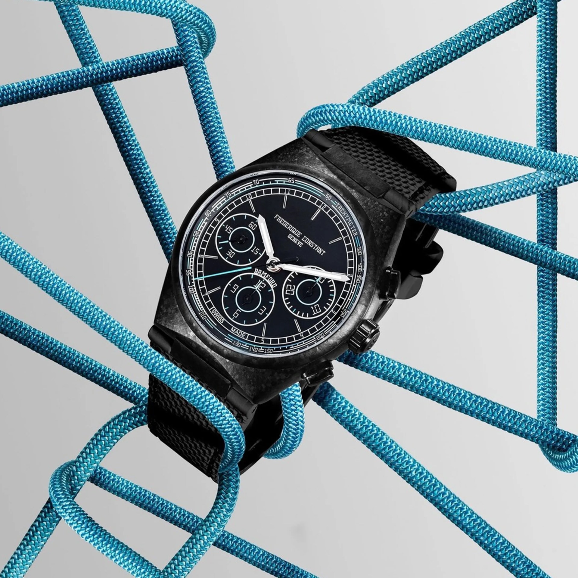 Black Frederique Constant wristwatch with chronograph dial and black textured strap entwined in blue rope.