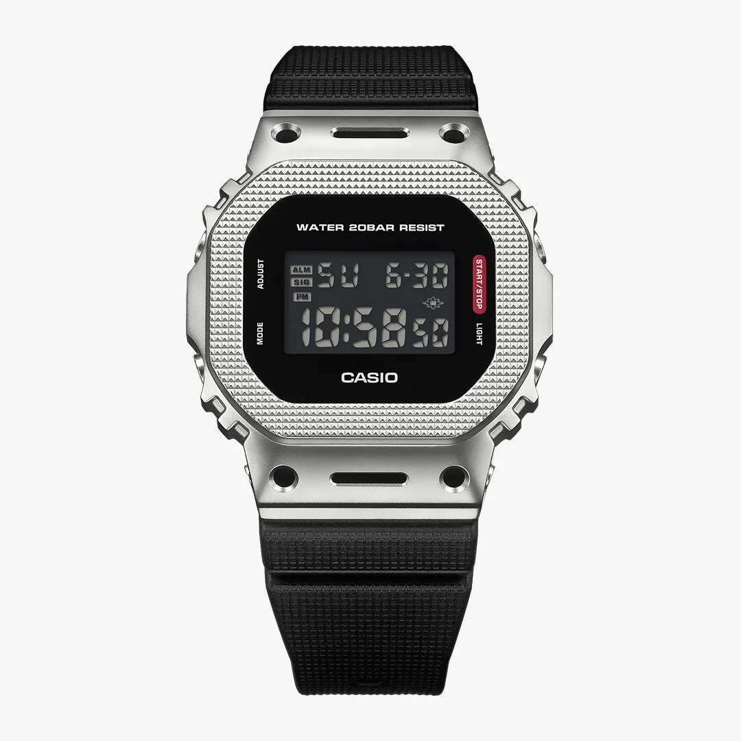 Digital Casio watch with a textured silver metal case and black resin strap showing time and date.