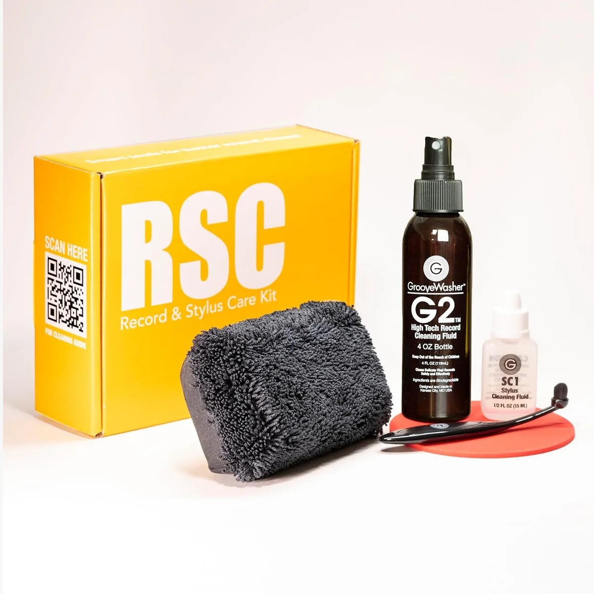 Yellow box labeled "RSC Record & Stylus Care Kit" with black cleaning brush, black spray bottle, small white bottle, and black stylus brush on a red pad.