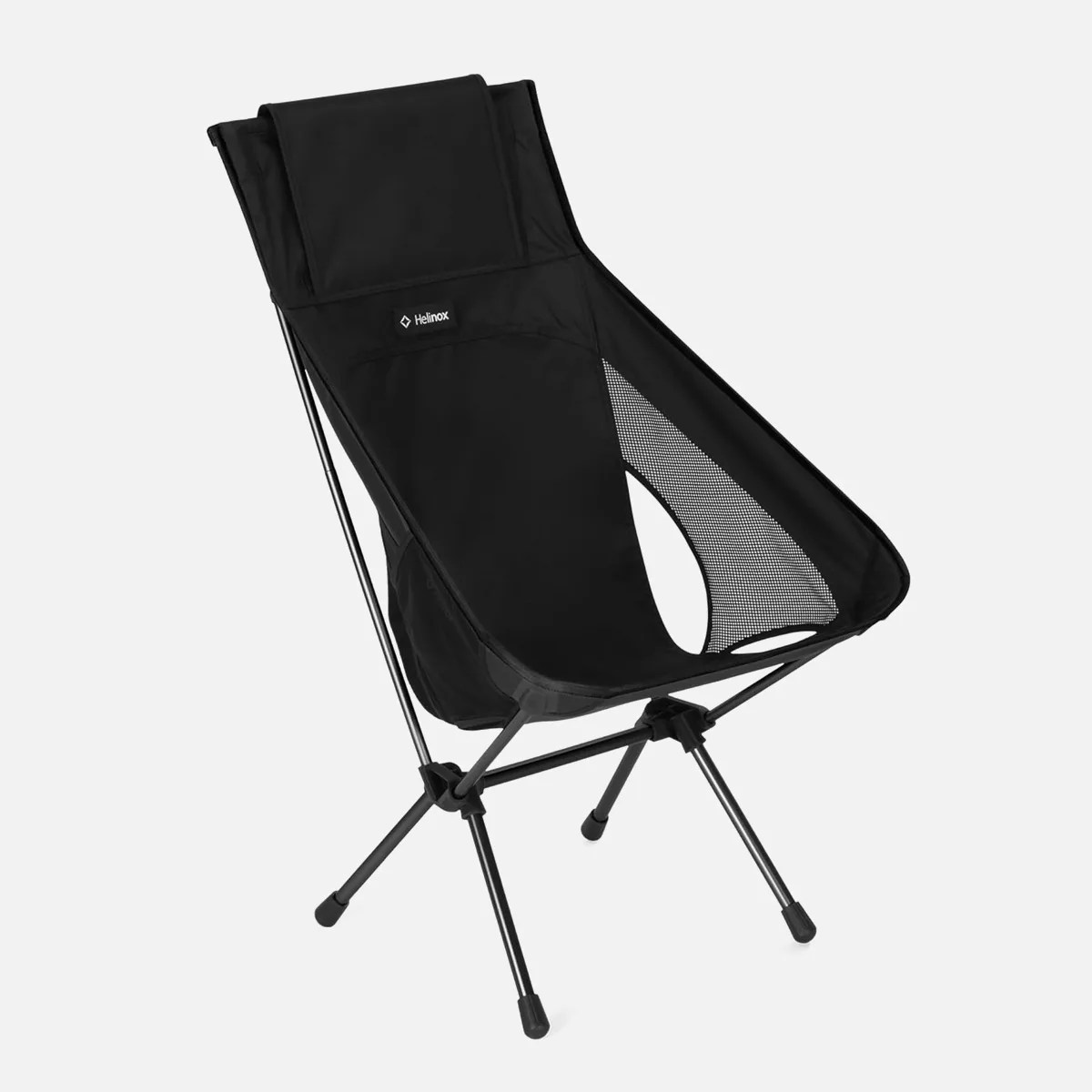 Black Helinox portable camping chair with mesh side panels and a metal frame.