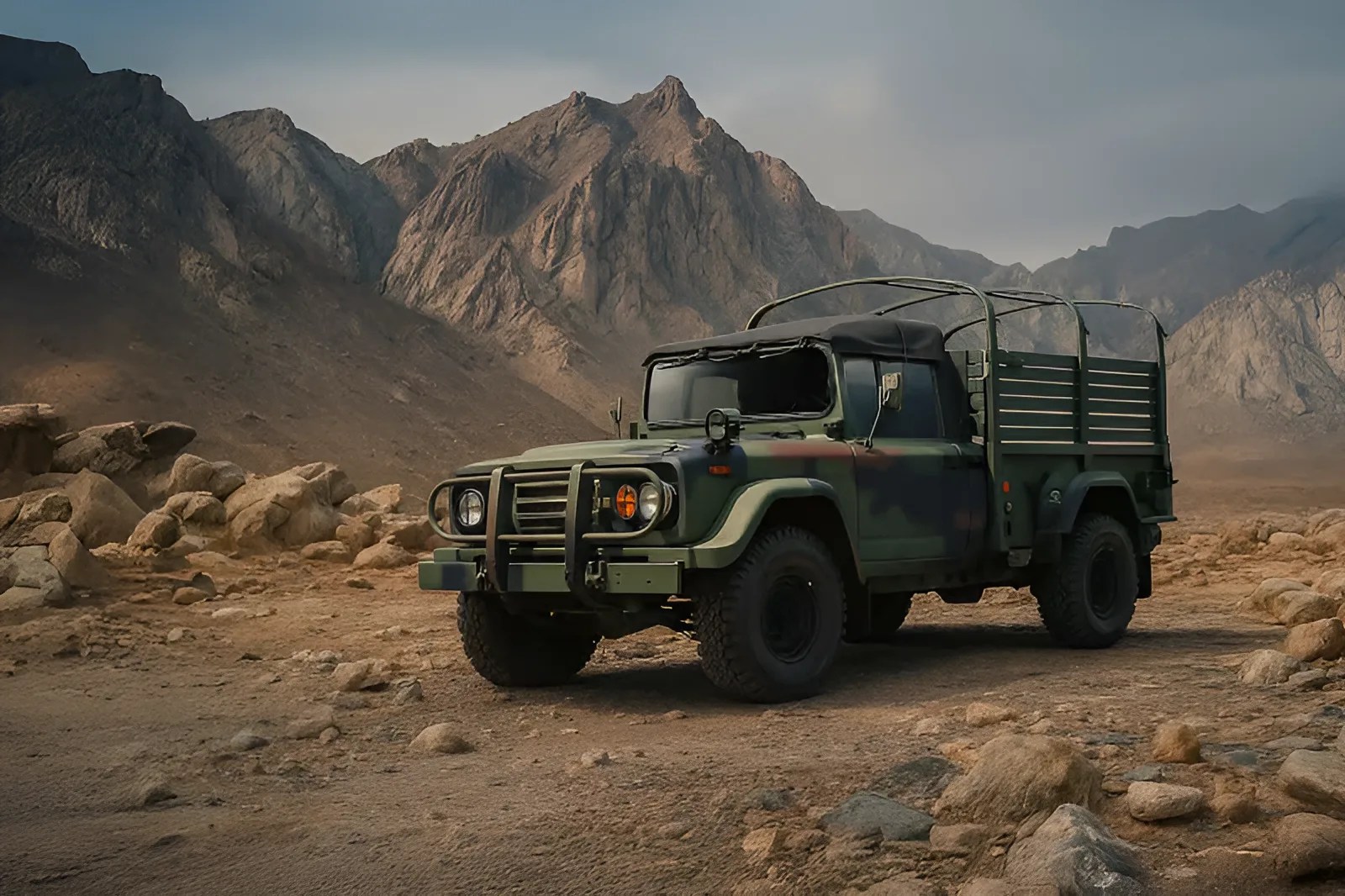 Green military-style off-road truck with a canvas-covered cargo bed parked on rocky desert terrain with mountains in the background.