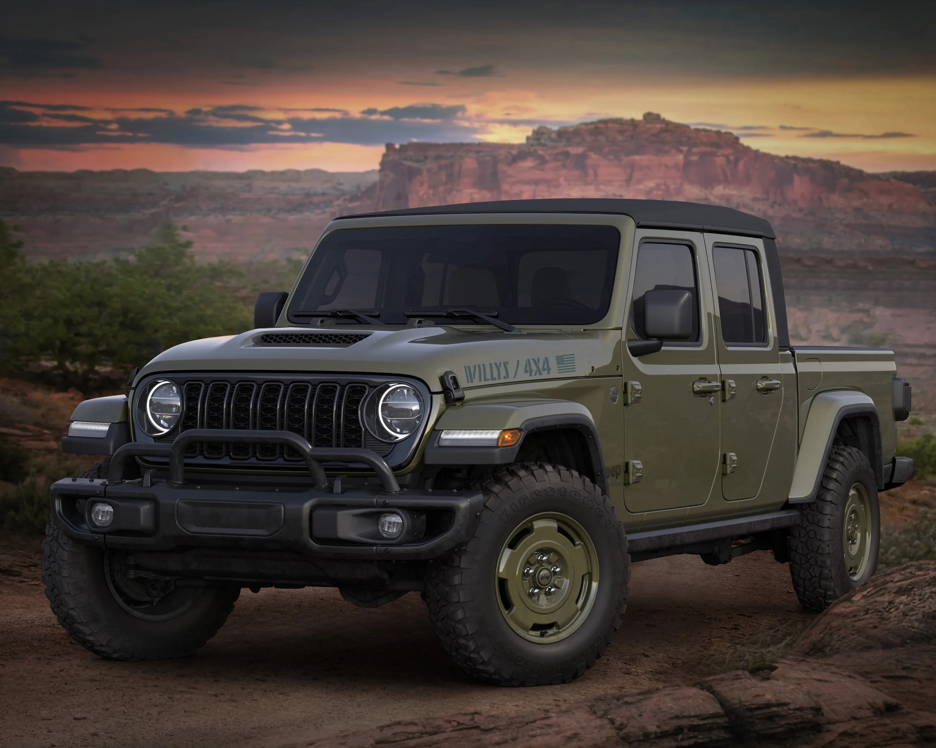 Olive green Jeep Gladiator Willys 4x4 pickup truck with black soft top parked on dirt with rocky desert background at sunset.
