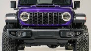 Front view of a purple Jeep with round LED headlights and black grille and bumper.