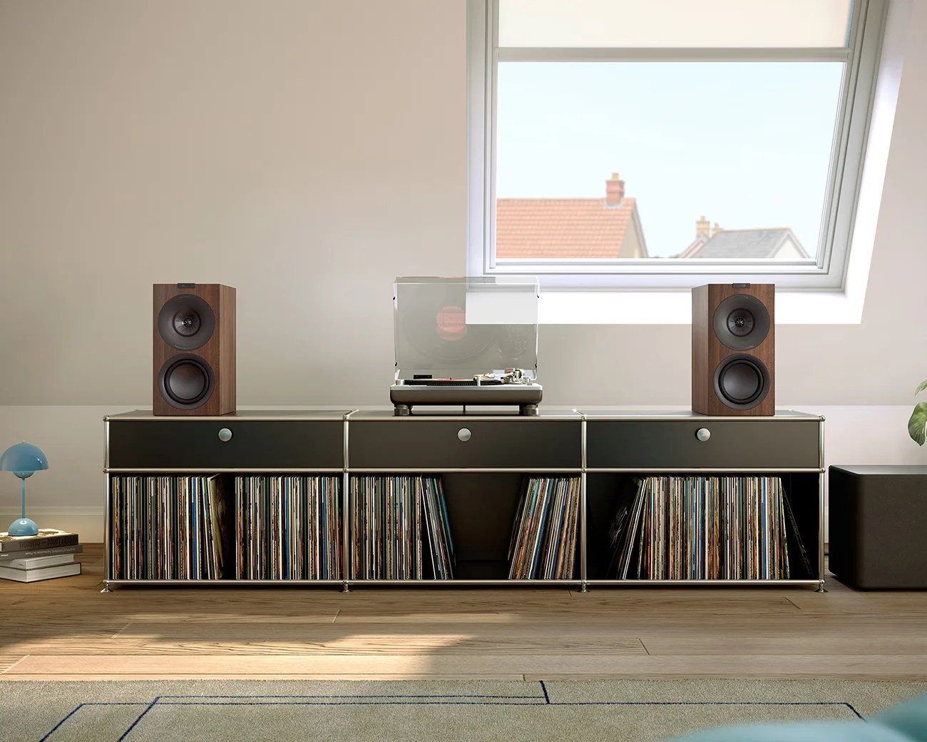 Black modular media console with vinyl records, wooden speakers, and a turntable under a skylight window.