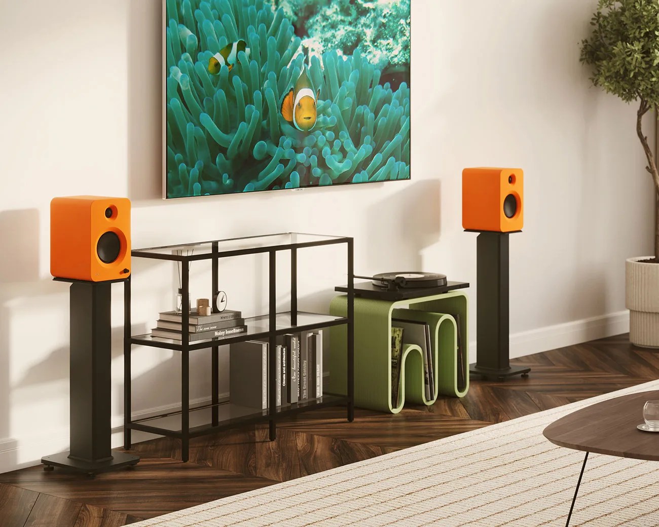 Pair of orange bookshelf speakers on black stands flanking a black metal shelving unit and green side table with a turntable.