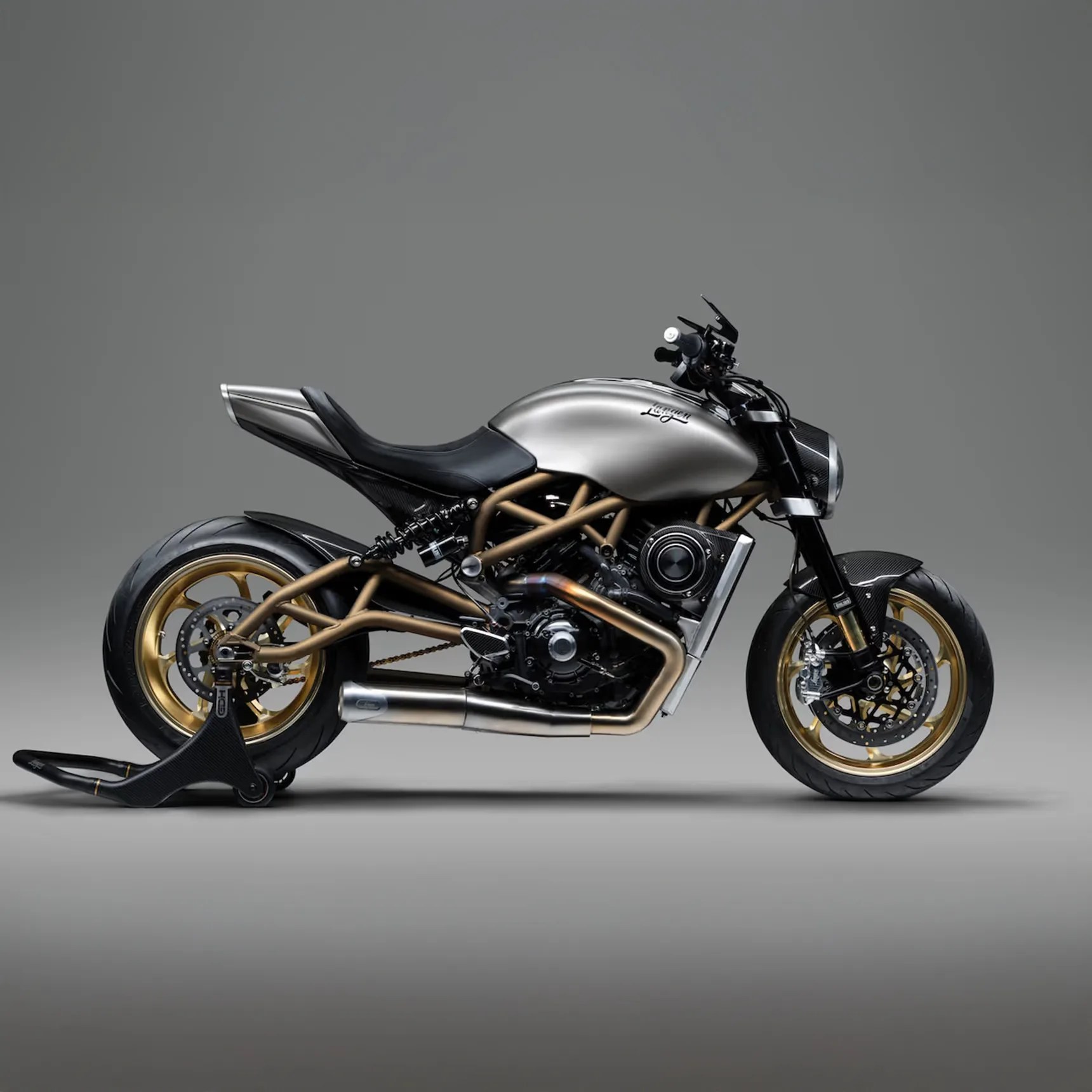 Matte silver and gold custom motorcycle with black seat and carbon fiber accents on a gray background.