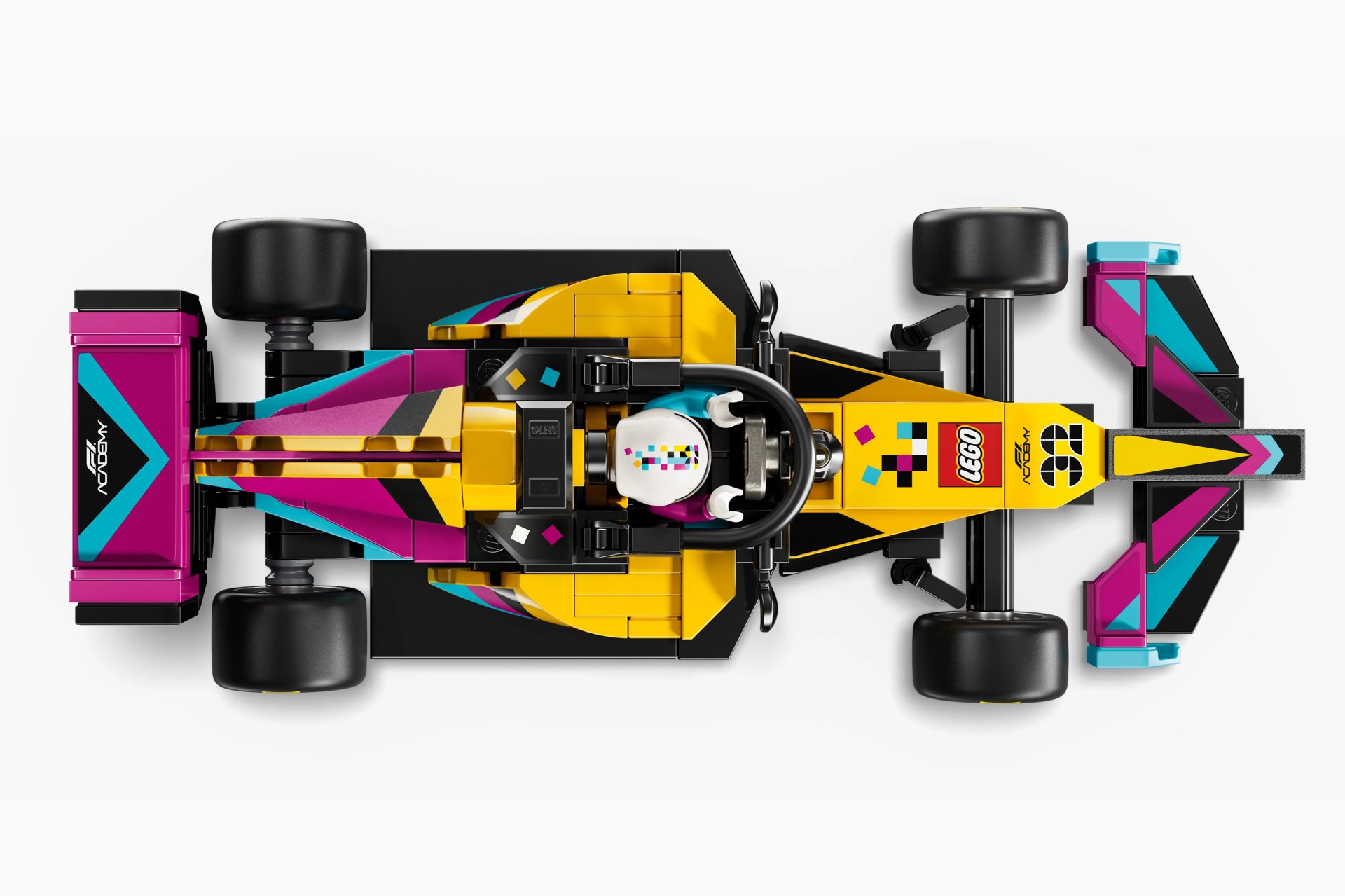 Top view of a LEGO Formula 1 race car model in yellow, pink, black, and blue colors with a driver minifigure inside.