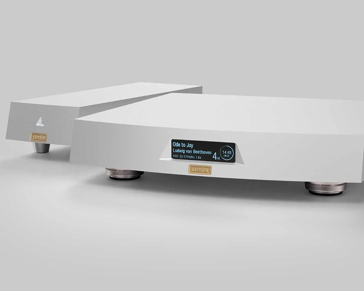 Two white Lumin audio components with digital display showing "Ode to Joy" by Beethoven on one unit.