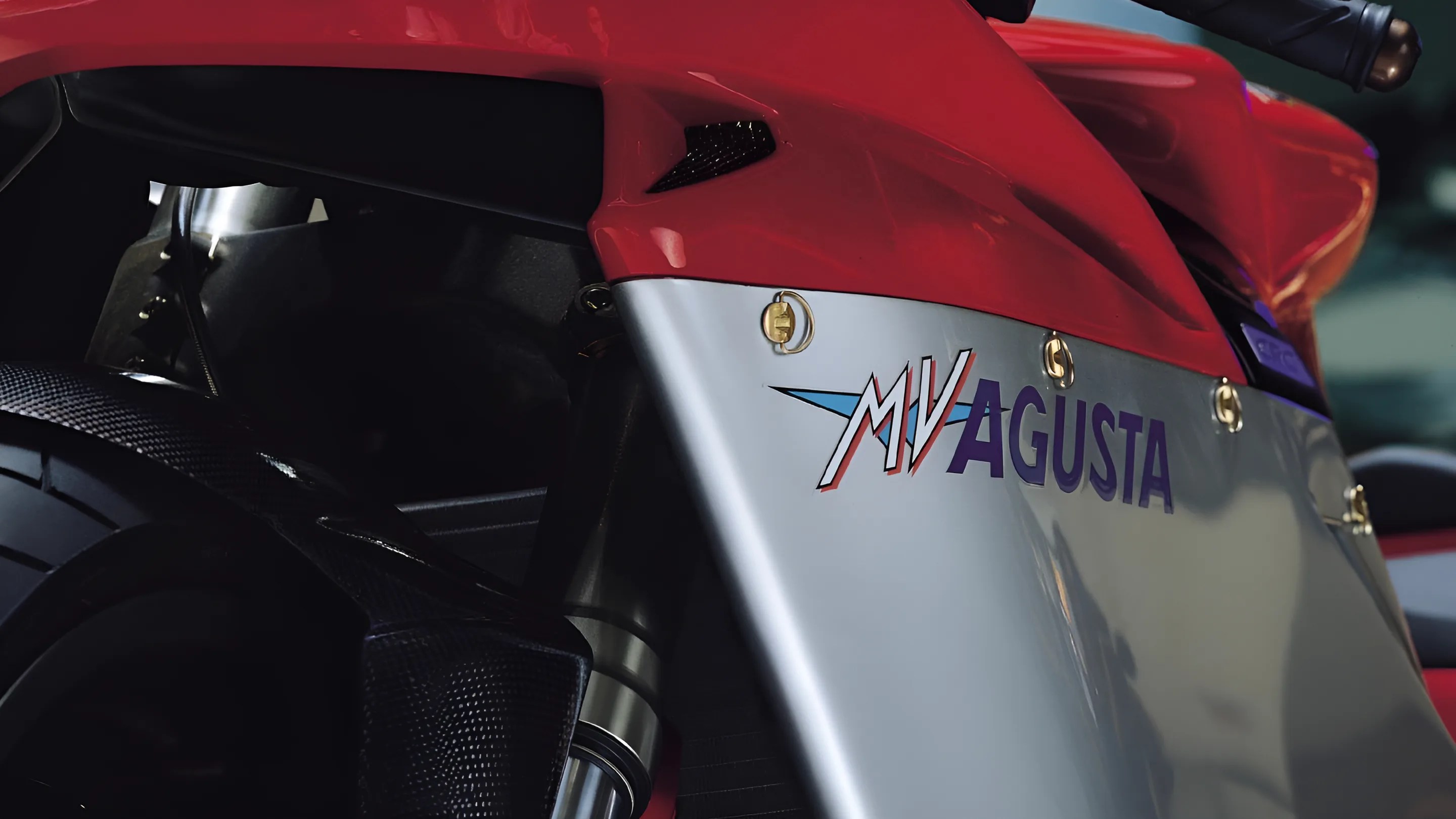 Close-up of red and silver MV Agusta motorcycle fairing with visible rear tire and suspension.