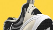 Close-up of a black and white Nike sneaker heel with striped pattern and textured sole against a yellow background.