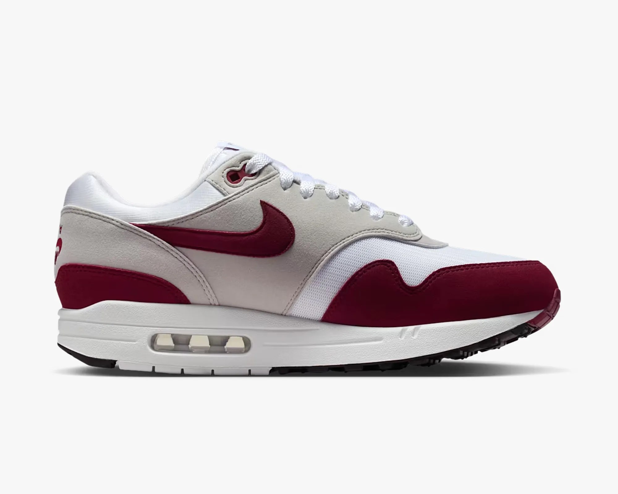 White and maroon Nike Air Max sneaker with visible air cushion in sole, shown from side.