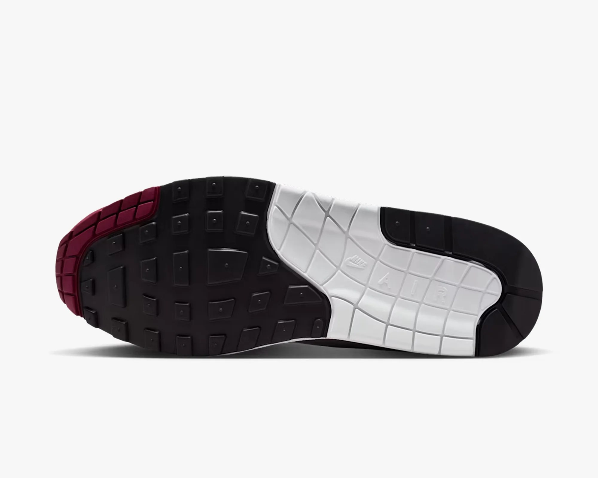 Sole of a Nike Air shoe with black, white, and maroon rubber tread and embossed "Nike Air" text.