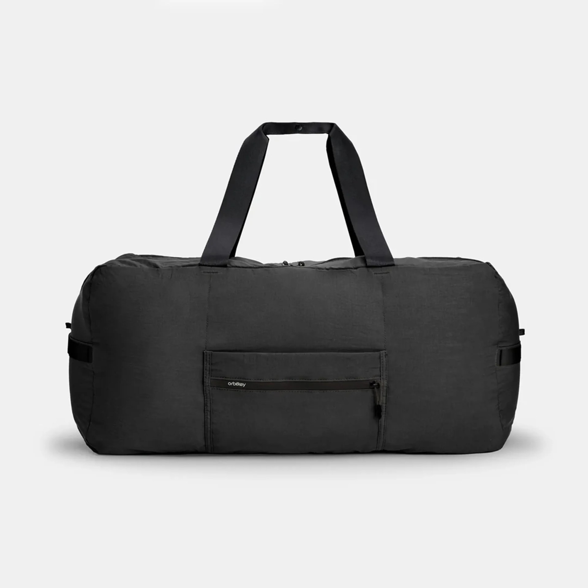 Black soft fabric duffel bag with front zippered pocket and two handles.