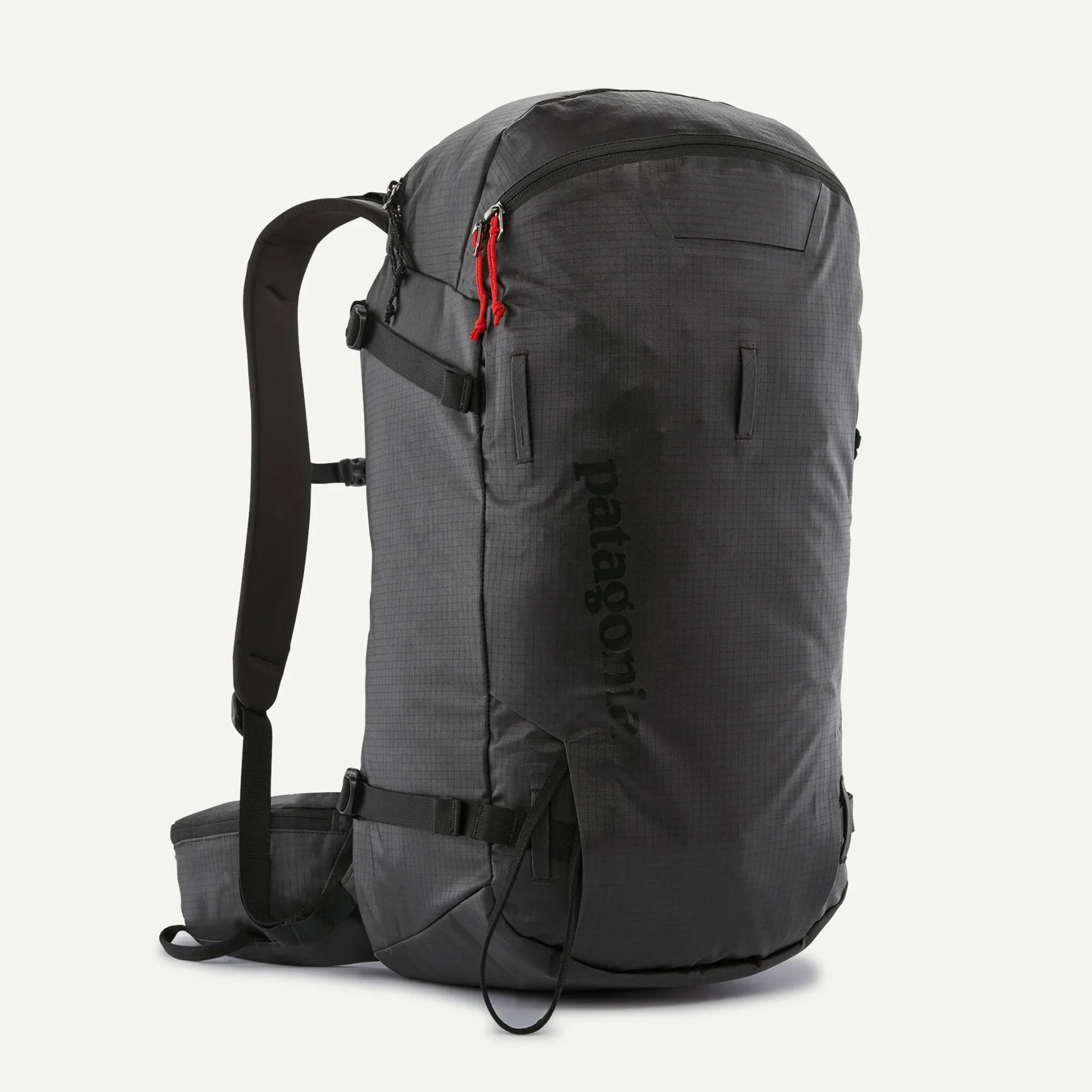 Black Patagonia backpack with red zipper pulls and padded shoulder straps.