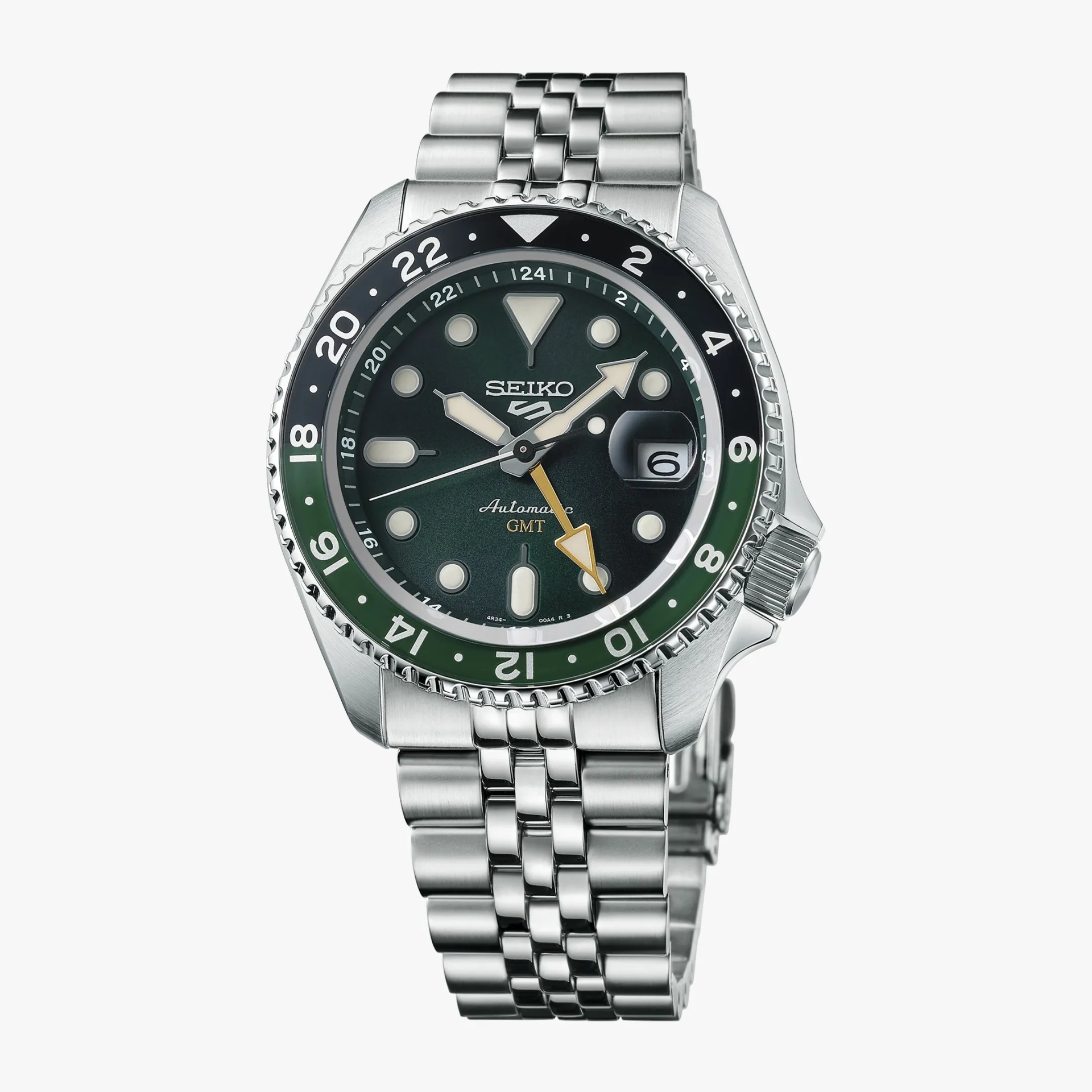 Stainless steel Seiko automatic GMT watch with black and green bezel and dark dial with luminous markers.