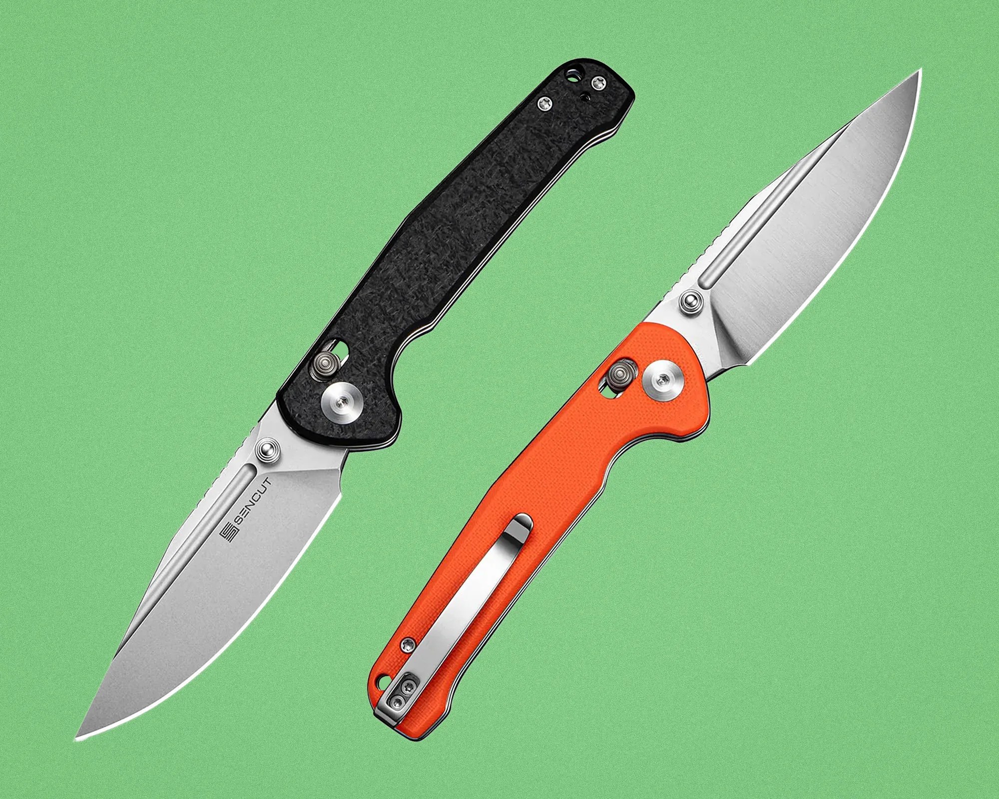 Two folding knives with stainless steel blades, one with a black textured handle and the other with an orange handle, on a green background.