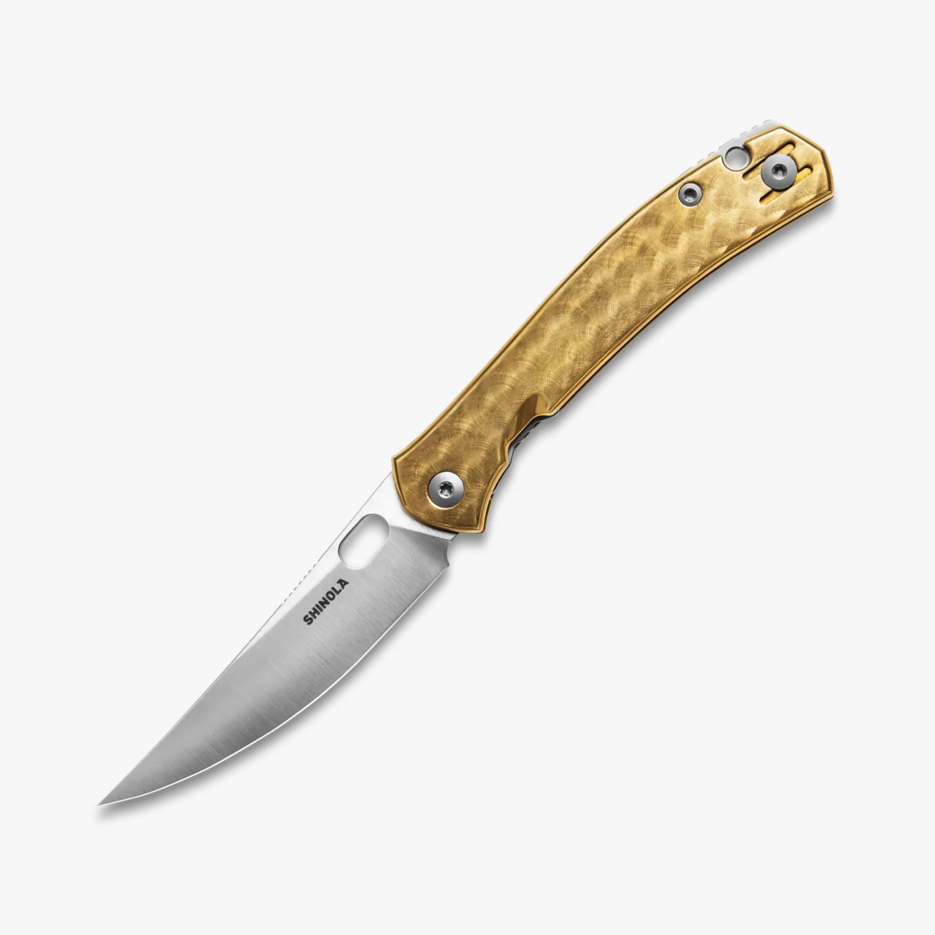 Folding knife with a silver blade and textured gold handle, branded "SHINOLA" on the blade.