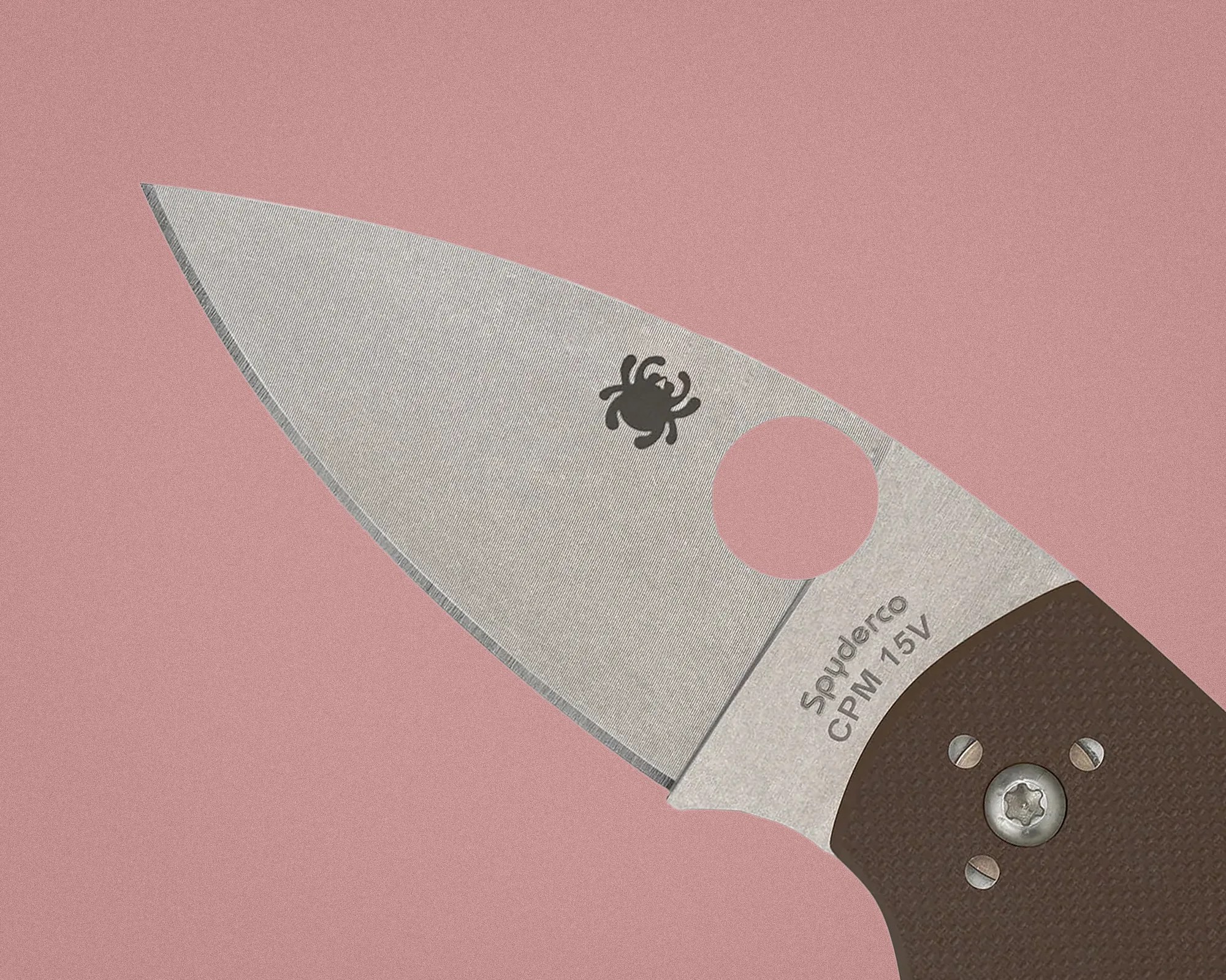 Close-up of a Spyderco CPM 15V stainless steel knife blade with a brown textured handle.