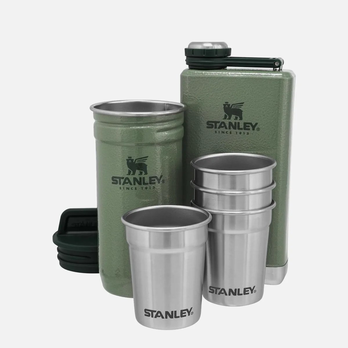Green Stanley metal flask and thermos with four stainless steel cups.