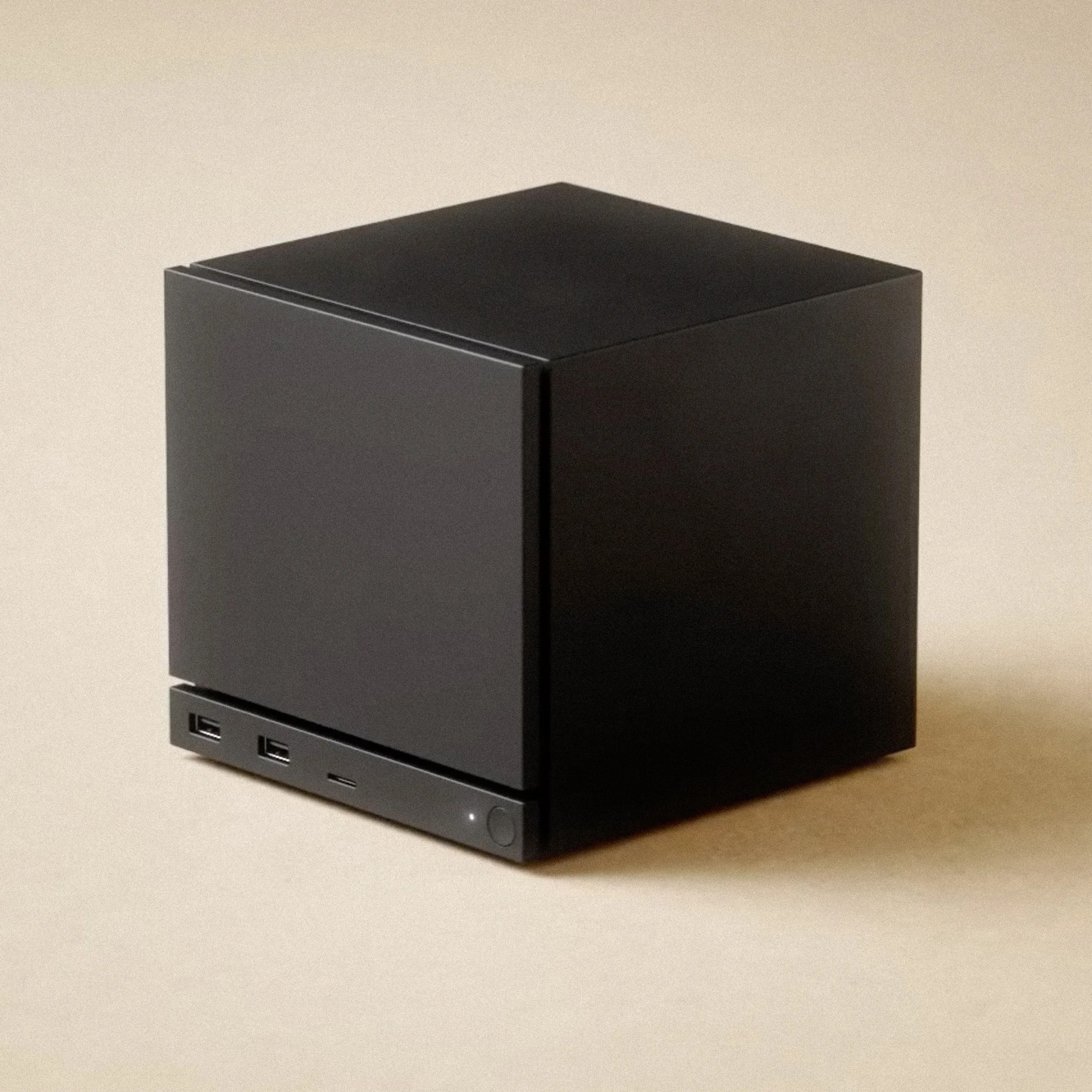 Matte black cube-shaped electronic device with two USB ports and a power button on the front panel.