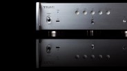 Silver TEAC audio device front panel with power switch, USB-C port, indicator lights, and toggle switch on a reflective black surface.