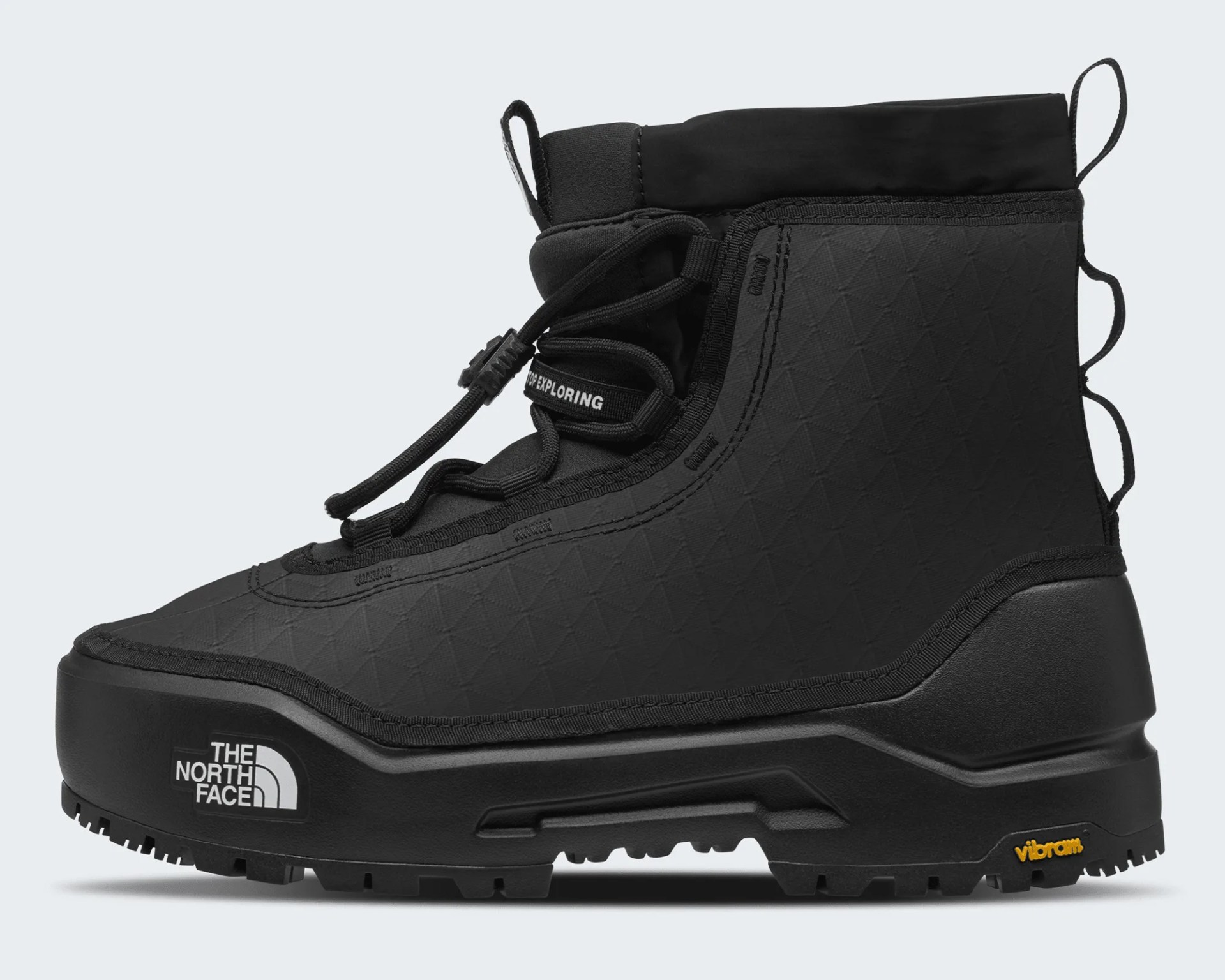 Black high-top hiking boot with quilted upper, elastic laces, and The North Face and Vibram logos on the sole.