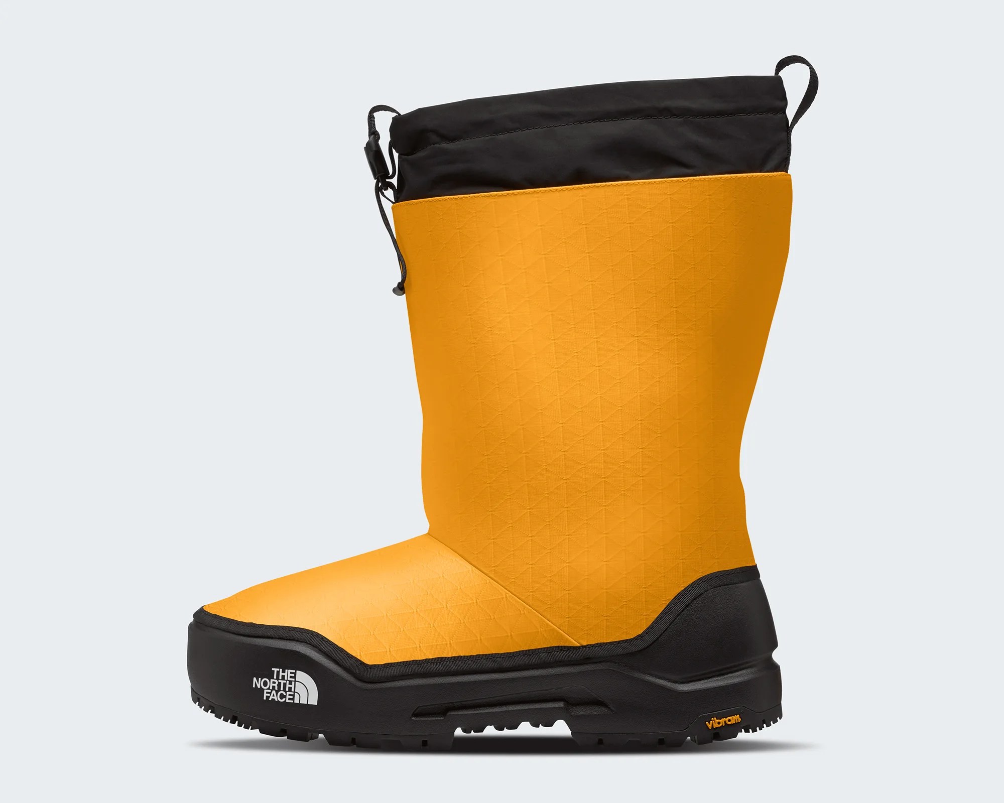 Yellow and black insulated winter boot with black sole and The North Face logo on the side.